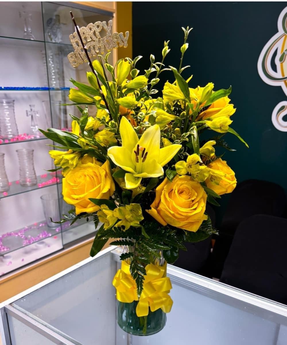 The Sunny Delight - This stunning yellow arrangement. Filled with beautiful yellow roses, lilies and more. Very elegant vase arrangement.