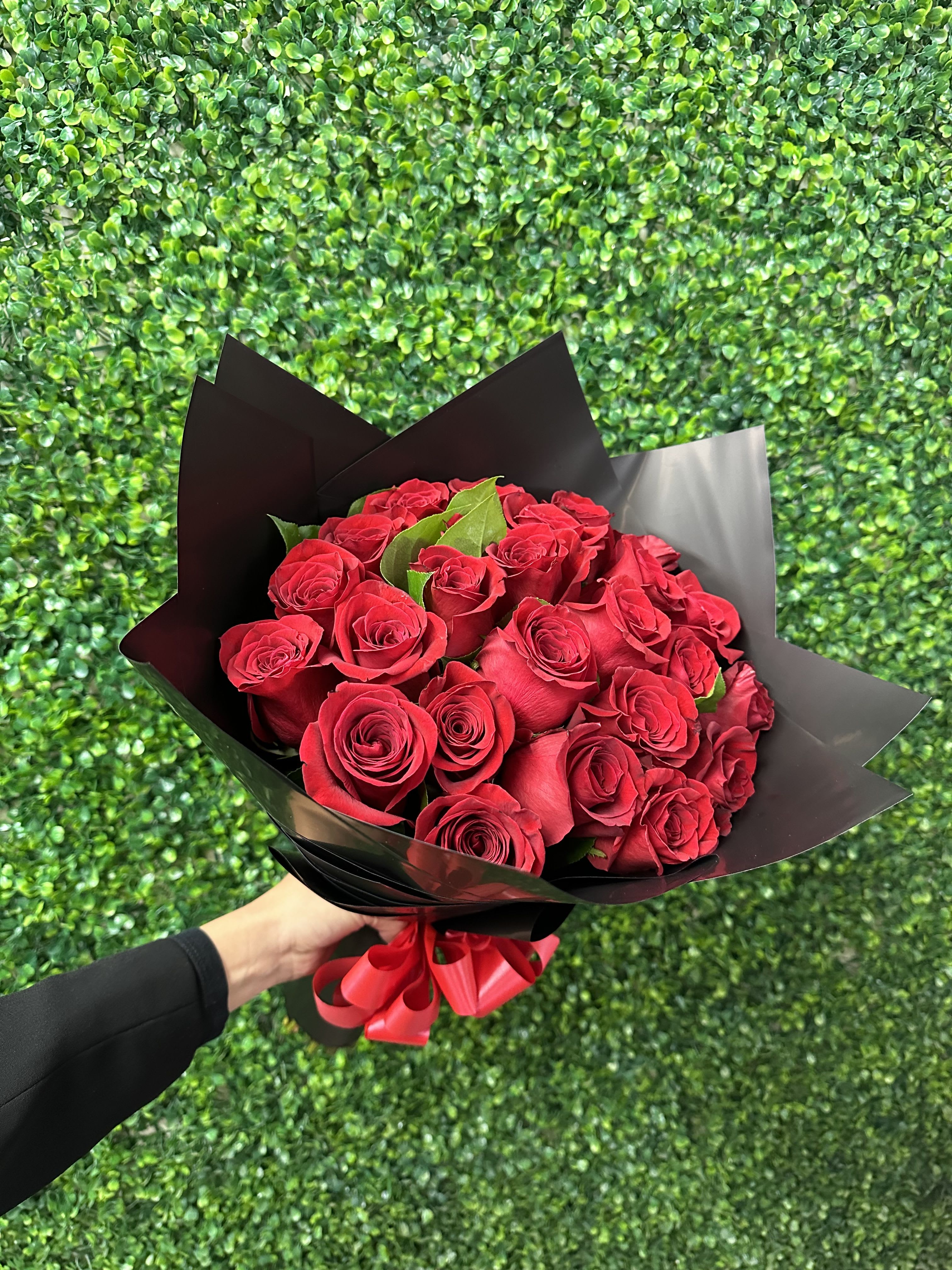 25 Kisses to You  - 25 of our premium red roses wrapped. Accompanied by modern wrap.  Upgrade your bouquet with a banner of 2 to 3 words to say what is in your heart.  (Banner Sold Separately) Wrapping paper might change upon availability to match flowers. 