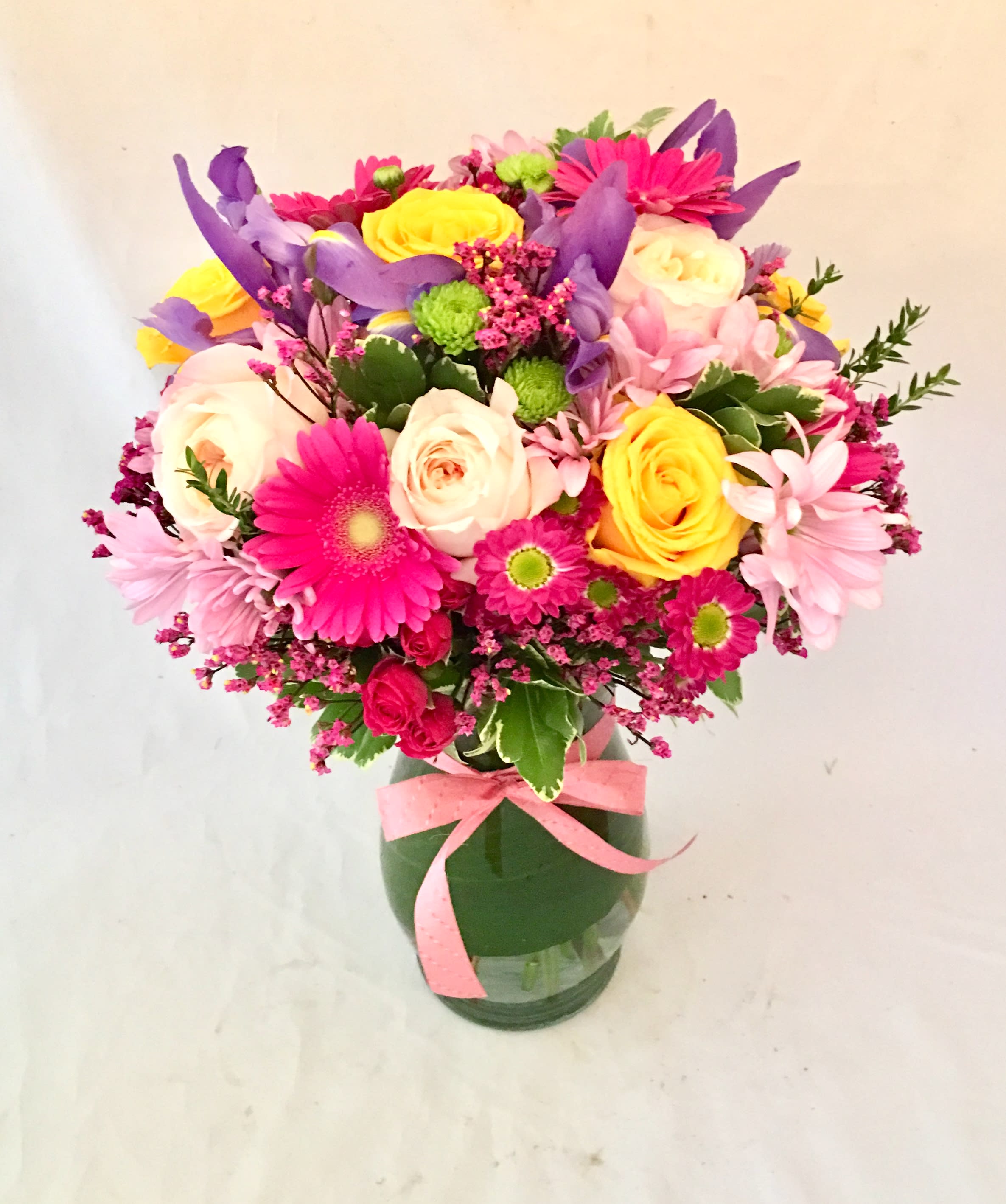 Stunner - Our brightest and biggest assortment of hued Roses, Iris, Mums, Gerbera Daisies, and seasonal blooms!