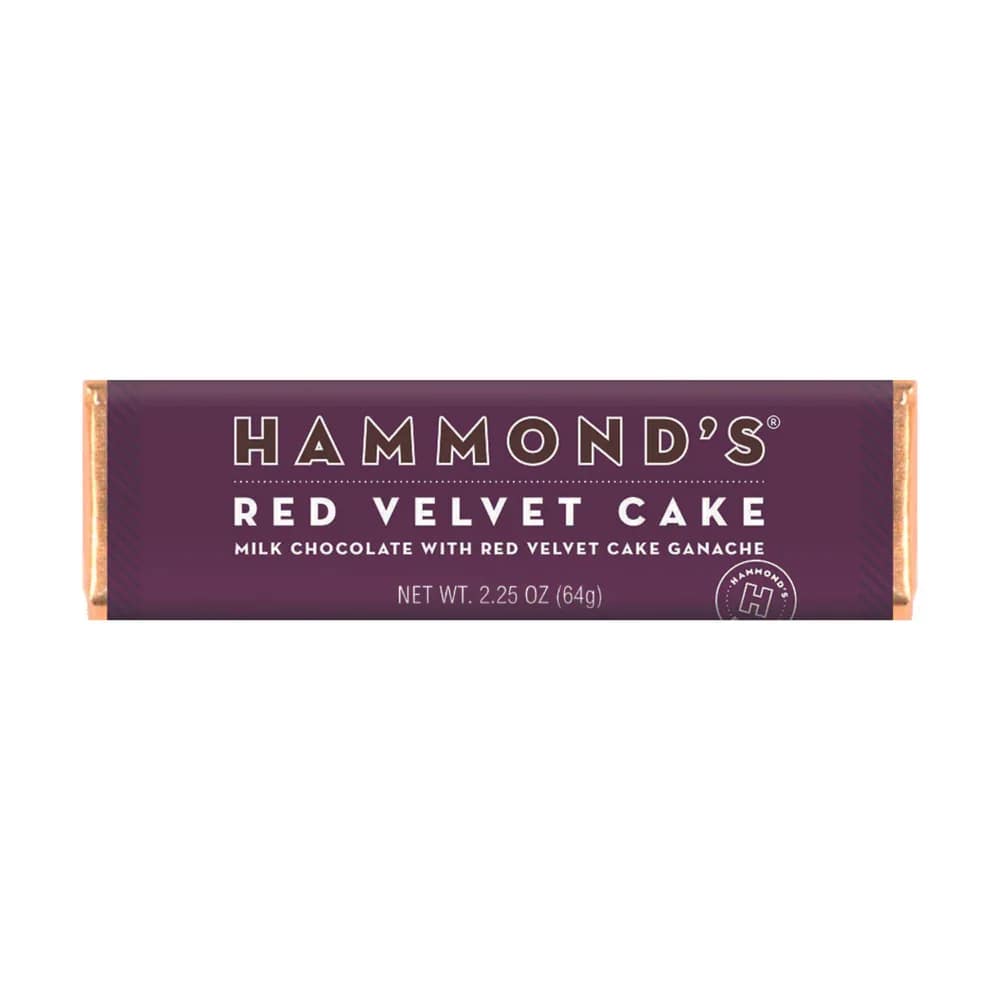 Hammond's Red Velvet Cake Chocolate Bar - Satisfy your cake cravings with Hammond's Red Velvet Cake Ganache Chocolate Bar. This Belgian milk chocolate candy bar is filled with a rich and decadent red velvet cake ganache, offering a playful twist on a classic dessert. Indulge in the sweet and creamy flavor of red velvet cake without the need for baking. Bite into this delicious chocolate bar and experience the perfect combination of smooth milk chocolate and luscious cake filling. OU-D Kosher 2.25 oz. Chocolate Bars Please note: Made with gourmet premium ingredients and fun flavors! Manufactured in a facility that processes egg, milk, mustard, peanuts, sesame, soy, sulfites, tree nuts, and wheat. 