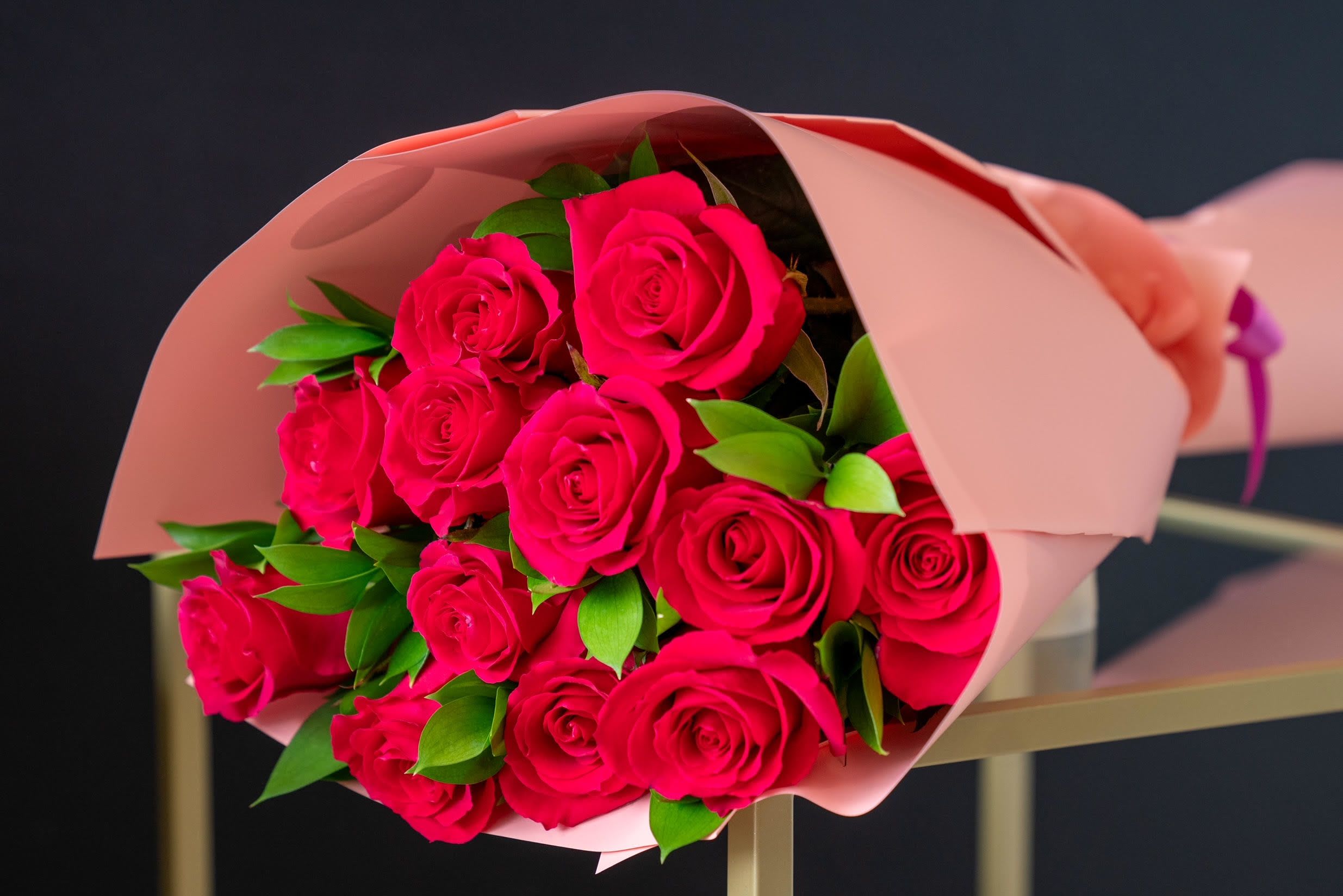 Dozen Long Stemmed Hot Pink Roses  - Dozen Long Stem Hot Pink Roses Bouquet is a bold and vibrant expression of love, passion, and admiration. This stunning bouquet features twelve long-stemmed hot pink roses, each carefully chosen for its striking color and perfect form. The rich, vivid pink blooms radiate energy and warmth, making this arrangement an unforgettable gift for any special occasion. Whether you’re celebrating love, friendship, or just want to brighten someone’s day, this bouquet is sure to leave a lasting impression with its beauty and elegance.  Arrangement Includes: -Fresh Cut Long Stemmed Hot Pink Roses (12 count, 60"-70") -Assorted Greenery -Custom Paper Wrapping -Custom Greeting Card -Care Instructions