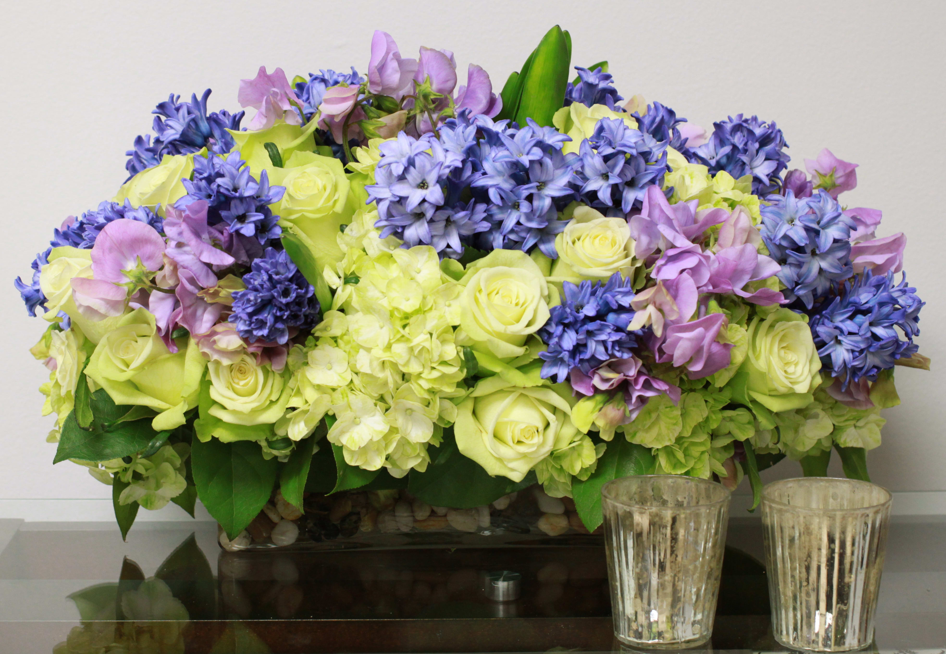 Spring Forward my Love. - This is a large arrangement filled with Lime Green Hydrangea, Fragrant purple Sweet Pea, Blue Hyacinth and Lavender Roses.  This award winning piece is sure sign of Spring and wishes for a Beautiful year ahead.  Let those that you love, know that you adore them.   