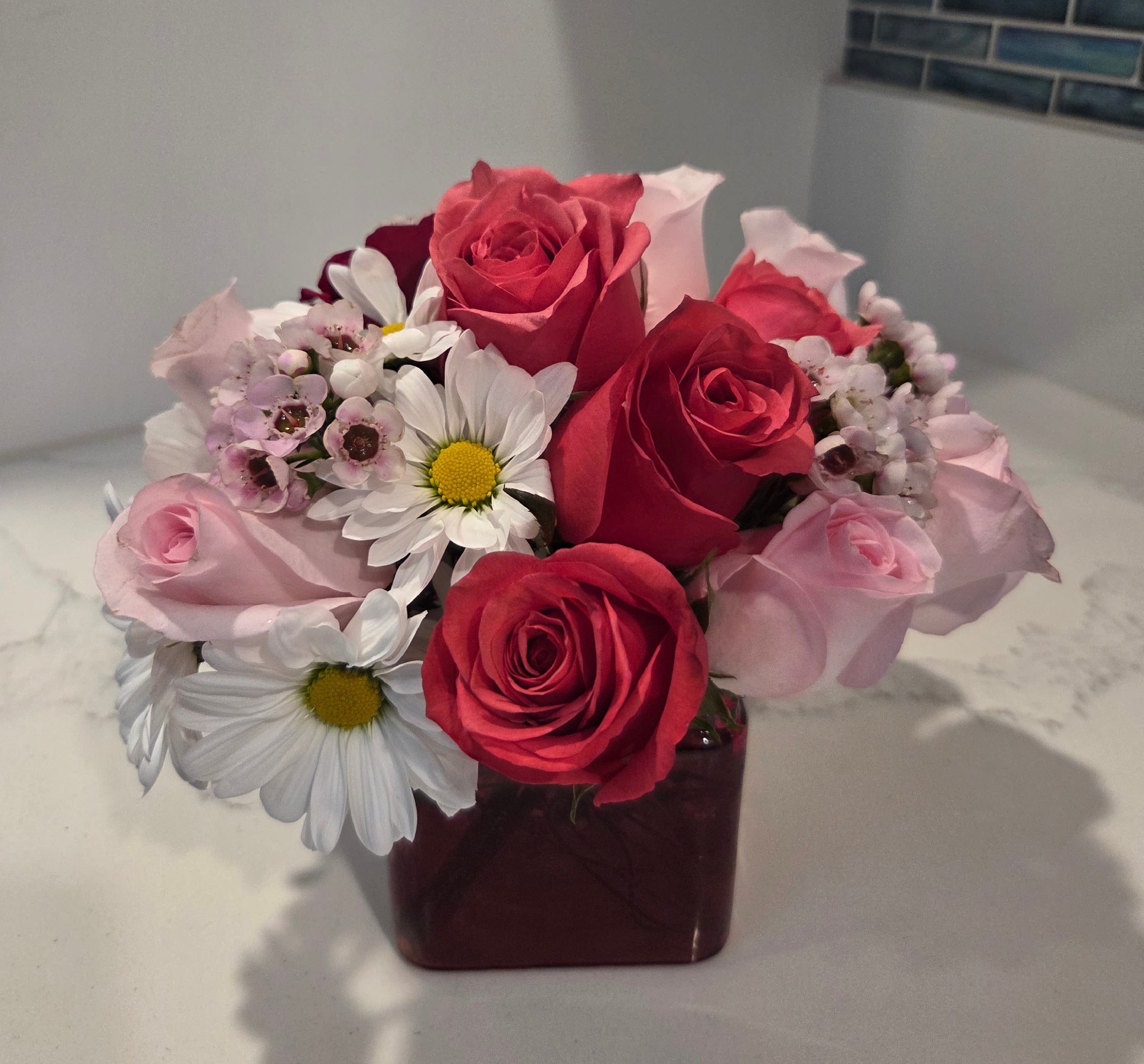 Miss Daisy - Filled with more than over 20 stems of pink, red and white blooms.  Delivered in a pink, red or clear cube vase.