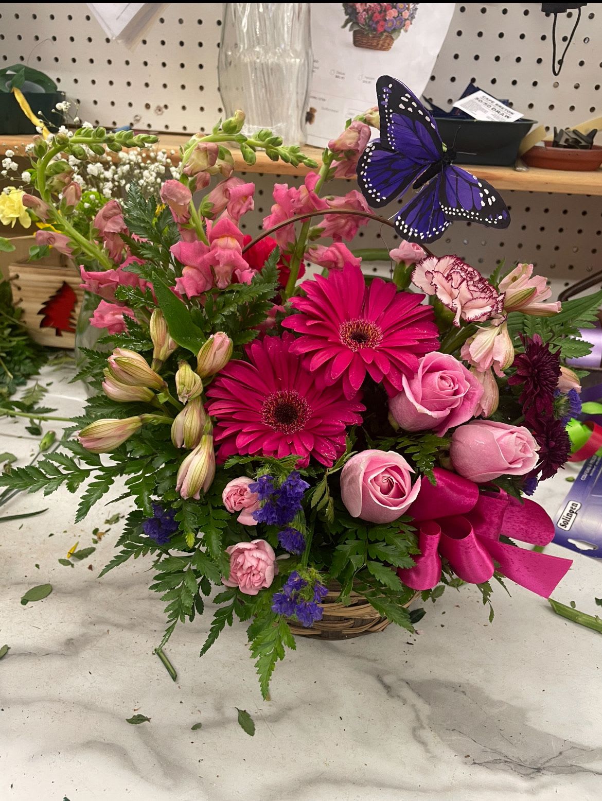 After the Rain by Lotherington's - A stunning floral basket with a pop of beautiful pink roses, gerbra daisies and carnations. This arrangement can only be described as refreshing. Send it to say thank you and to show your appreciation and love!  Approximate Dimensions: 15"D x 12"H  ***Colors and blooms maybe substituted depending on season and availability ***