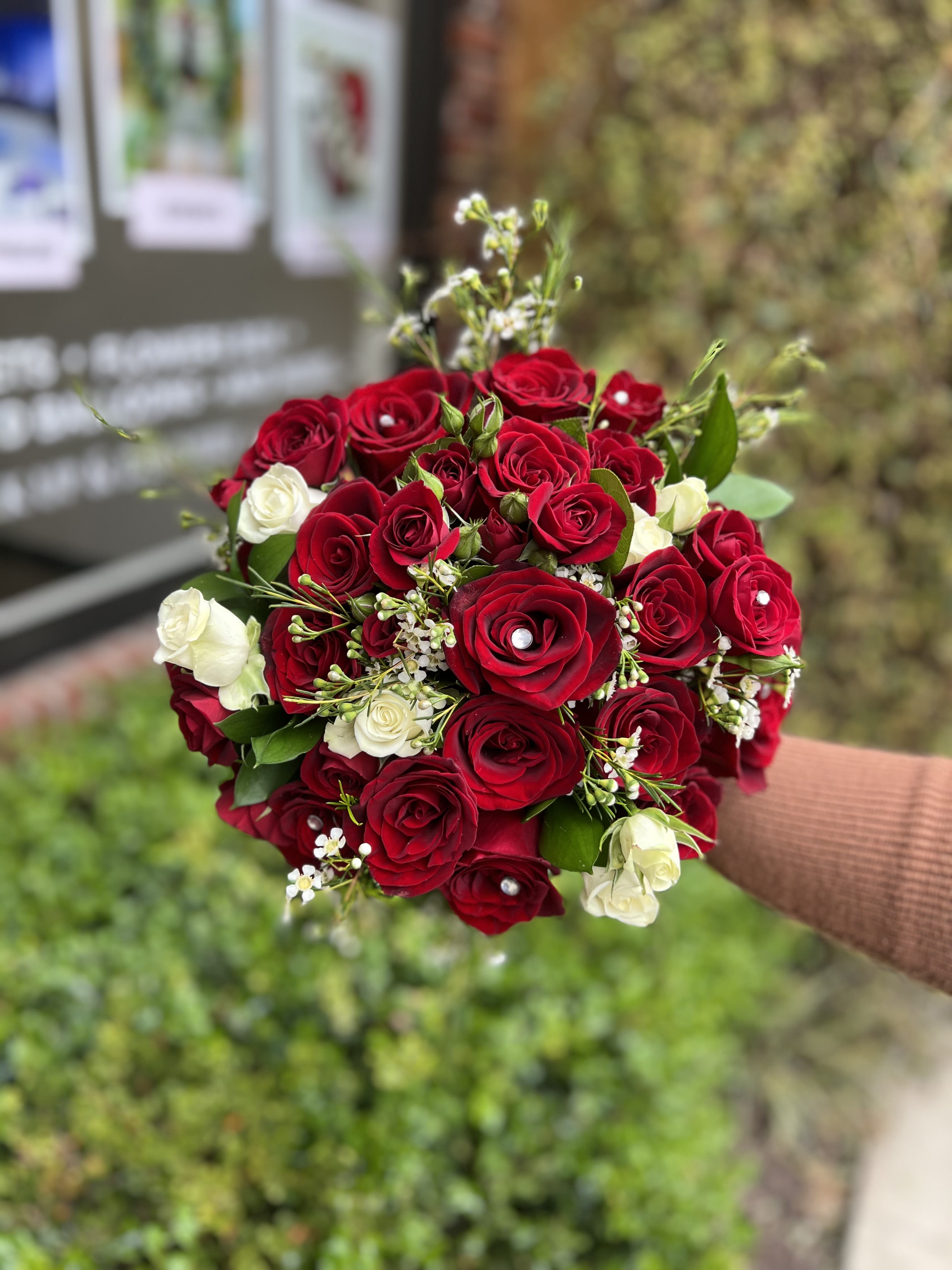Wedding thirteen - Round natural bouquet with red Roses , spray roses and wax with a touch of green.