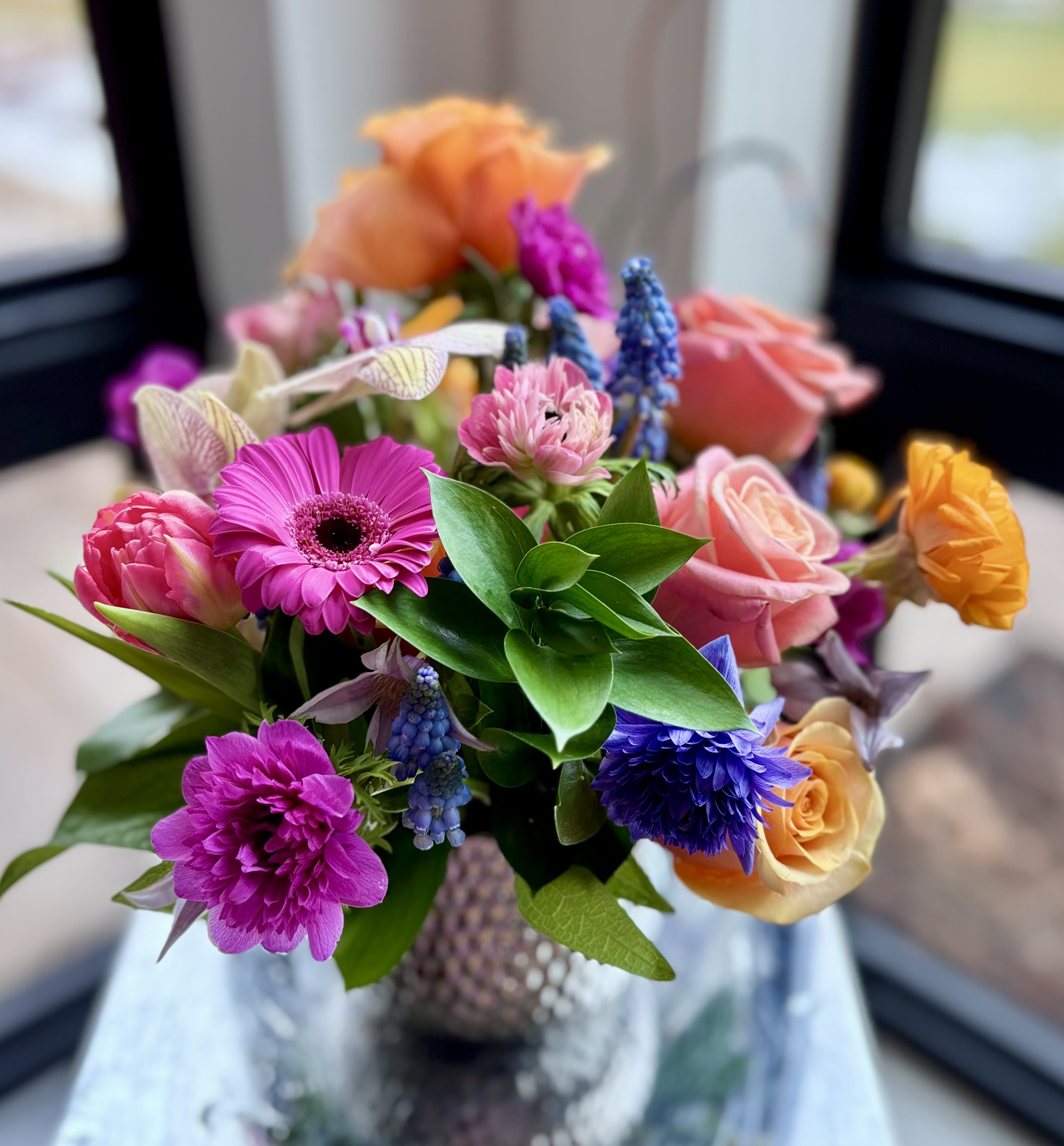 Delightful - Cute colorful flower arrangement of premium flowers in a silver Supernova Pot vase for any occasion your celebrate. Even small arrangements are meaningful and Michaela loves making those. You can upgrade for bigger sizes. The choice of flowers and colors vary, but rest assured Michaela carefully selects a lovely happy mix of blooms.