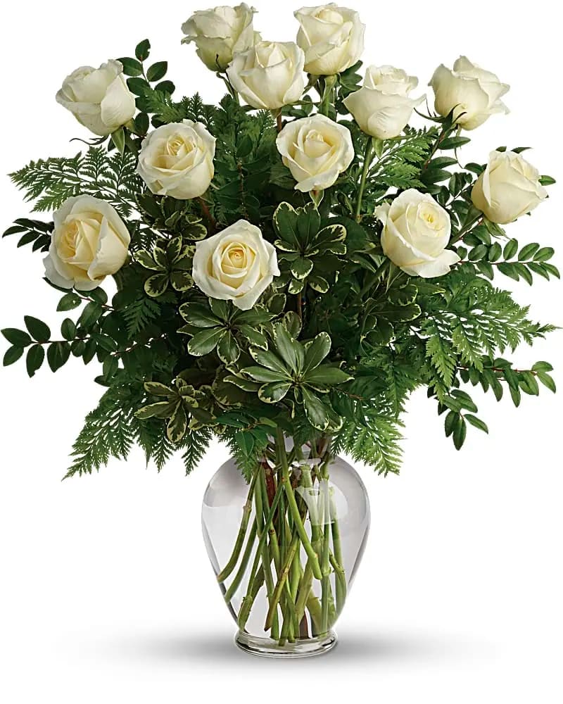 Joy Of Roses Bouquet - A joyful gesture of love and affection, this chic arrangement of pure white roses with fresh greens is a special surprise on any occasion. White roses are arranged with leatherleaf fern huckleberry and variegated pittosporum. Delivered in a clear vase. 
