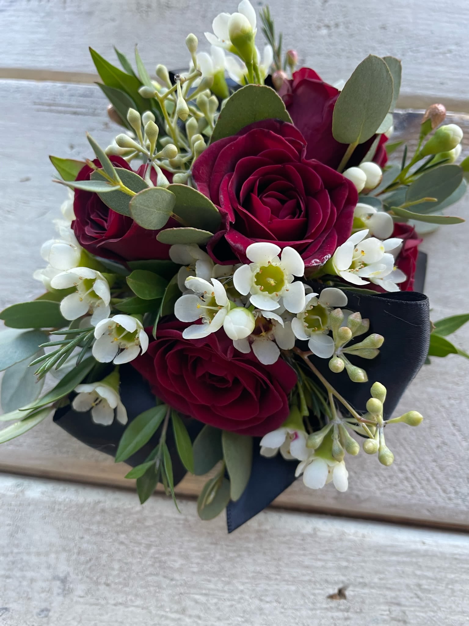 Wrist Corsage #9 Red Roses - Wrist corsage with red spray roses, greenery and filler. Please specify ribbon color.