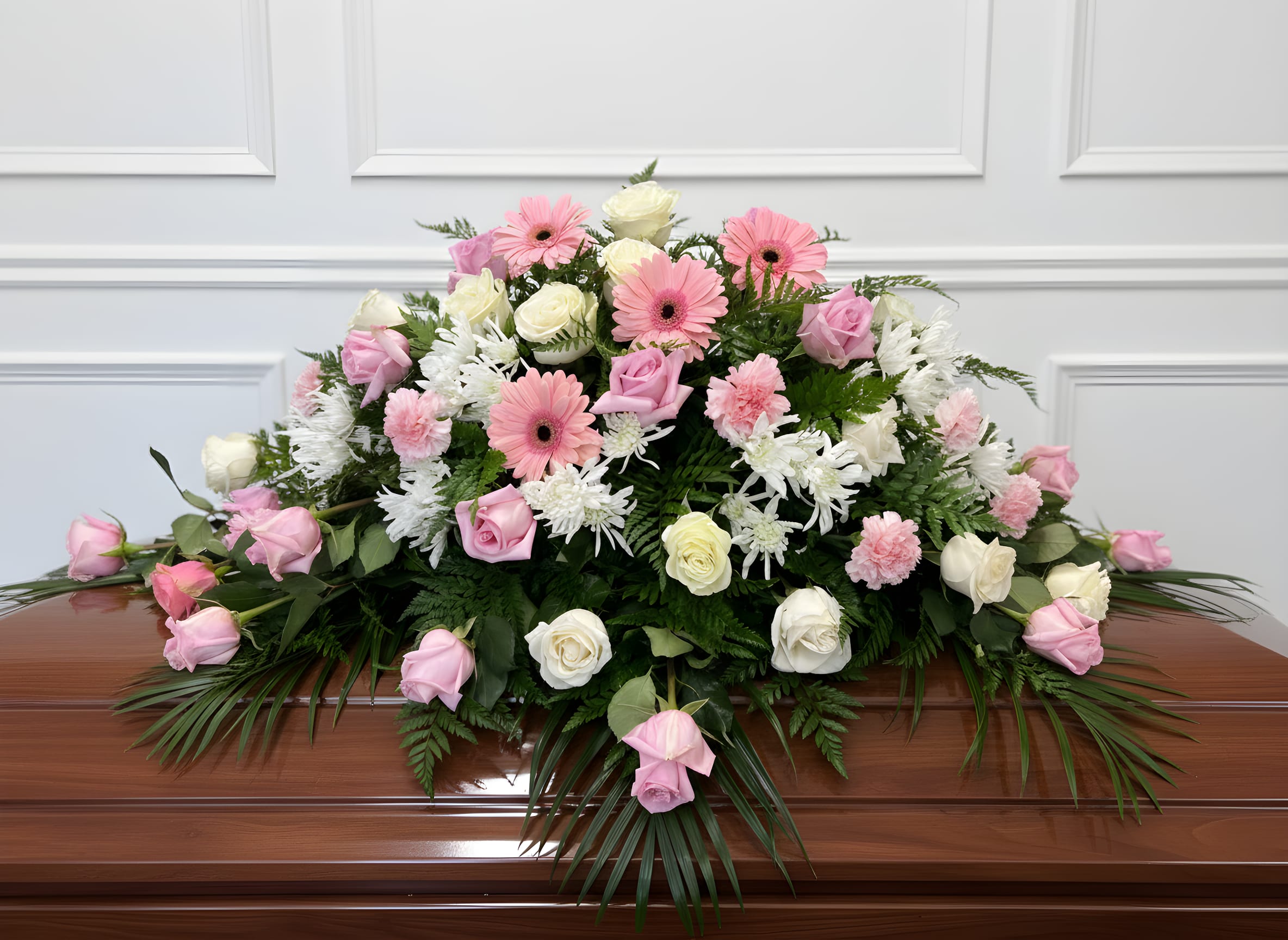 Blush of Peace Casket Spray - A soft and elegant casket spray featuring delicate pink and white roses accented with complementary blooms and fresh greenery. This gentle tribute symbolizes love, grace, and tender remembrance, offering a peaceful and heartfelt farewell.
