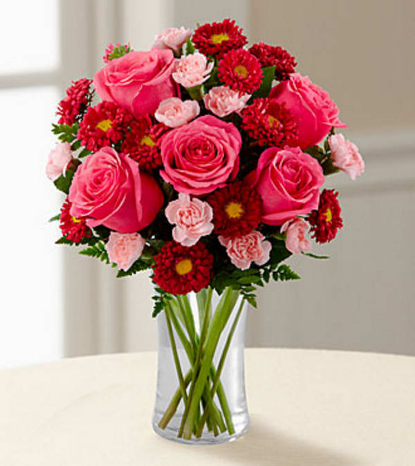 The Precious Heart™ Bouquet by FTD® - VASE INCLUDED - The Precious Heart Bouquet by FTD® is a blushing display of loving kindness. Fuchsia roses are sweetly stunning amongst red matsumoto asters, pink mini carnations and lush greens. Arranged in a classic clear glass vase, this bouquet boasts pink perfection to convey your warmest wishes.  GOOD bouquet includes 11 stems. Approximately 15"H x 11"W. BETTER bouquet includes 15 stems. Approximately 16"H x 12"W. BEST bouquet includes 19 stems. Approximately 17"H x 13"W. Your purchase includes a complimentary personalized gift message.