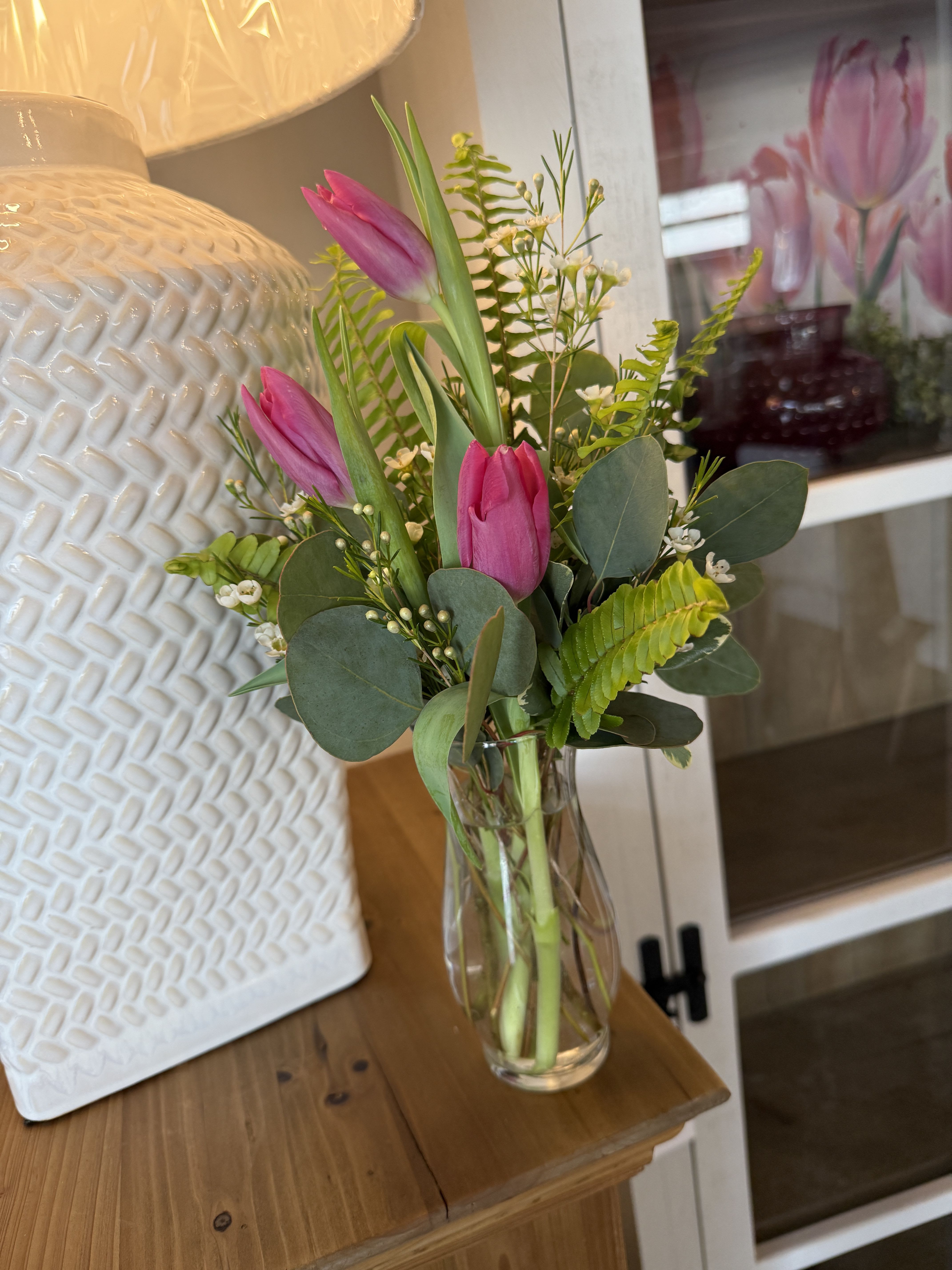 Spring Sentiments - s petite arrangement features vibrant tulips and lush greens designed to bring a pop of spring into any space. A lovely “just because” gift or a simple treat for yourself.