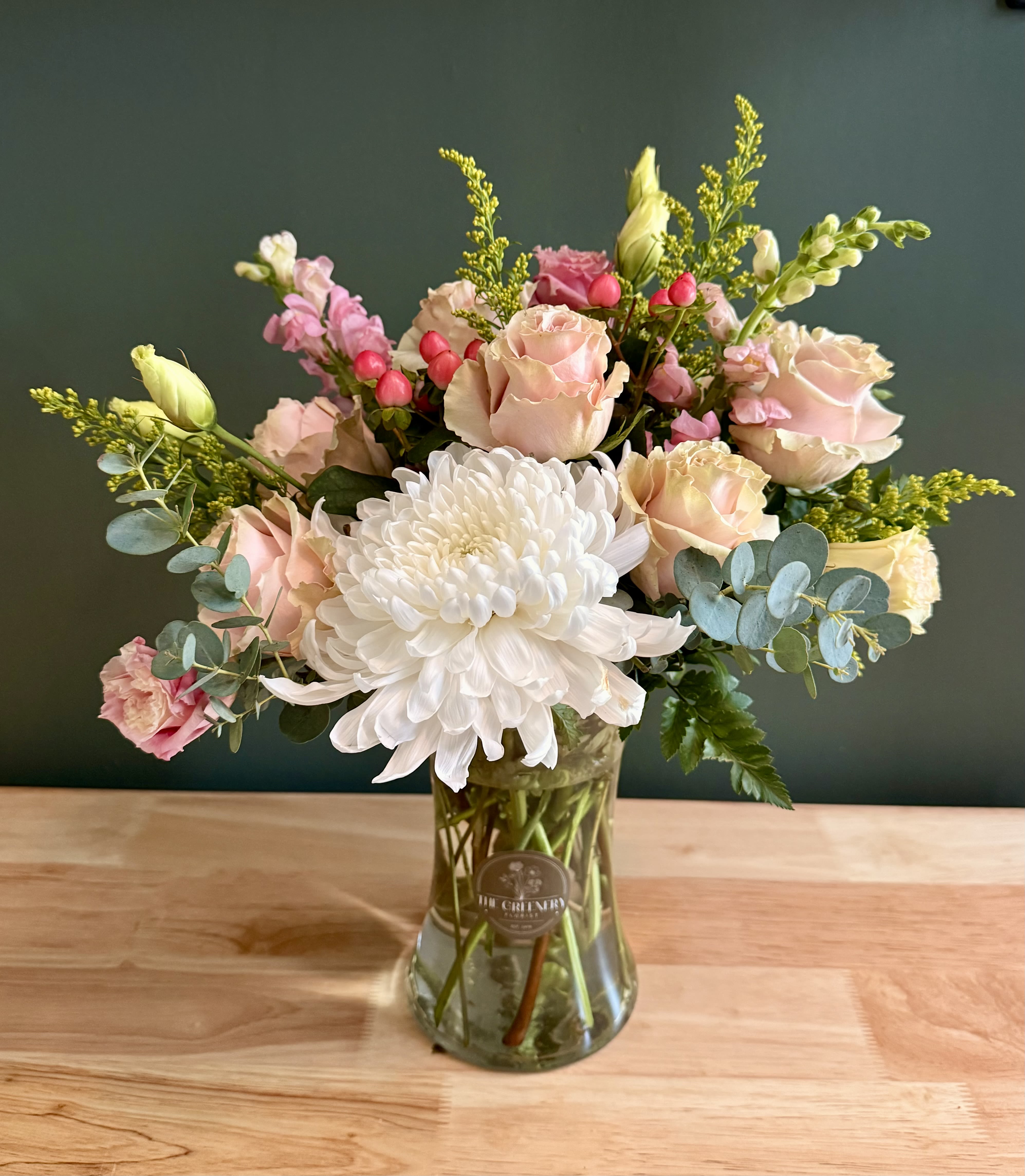 Charleston Charm - A soft, sophisticated floral design for moments that deserve a touch of elegance. Featuring: - Ecuadorian Roses - White Cremone - Solidago - Delicate Lisianthus - Hypericum - Styled with premium seasonal foliage Presentation Options: Tall clear vase measures approximately 8"9" in H. Every order includes: A custom message card - simply enter your message at checkout and we'll take care of the rest. As a local florist in Charleston South Carolina, everything is made fresh by us here at our flower shop Downtown Charleston.  Please note: Flowers are subject to seasonal availability. If a listed flower is unavailable, our designers will substitute it with flowers of a similar shape, color, and style to maintain the overall aesthetic.