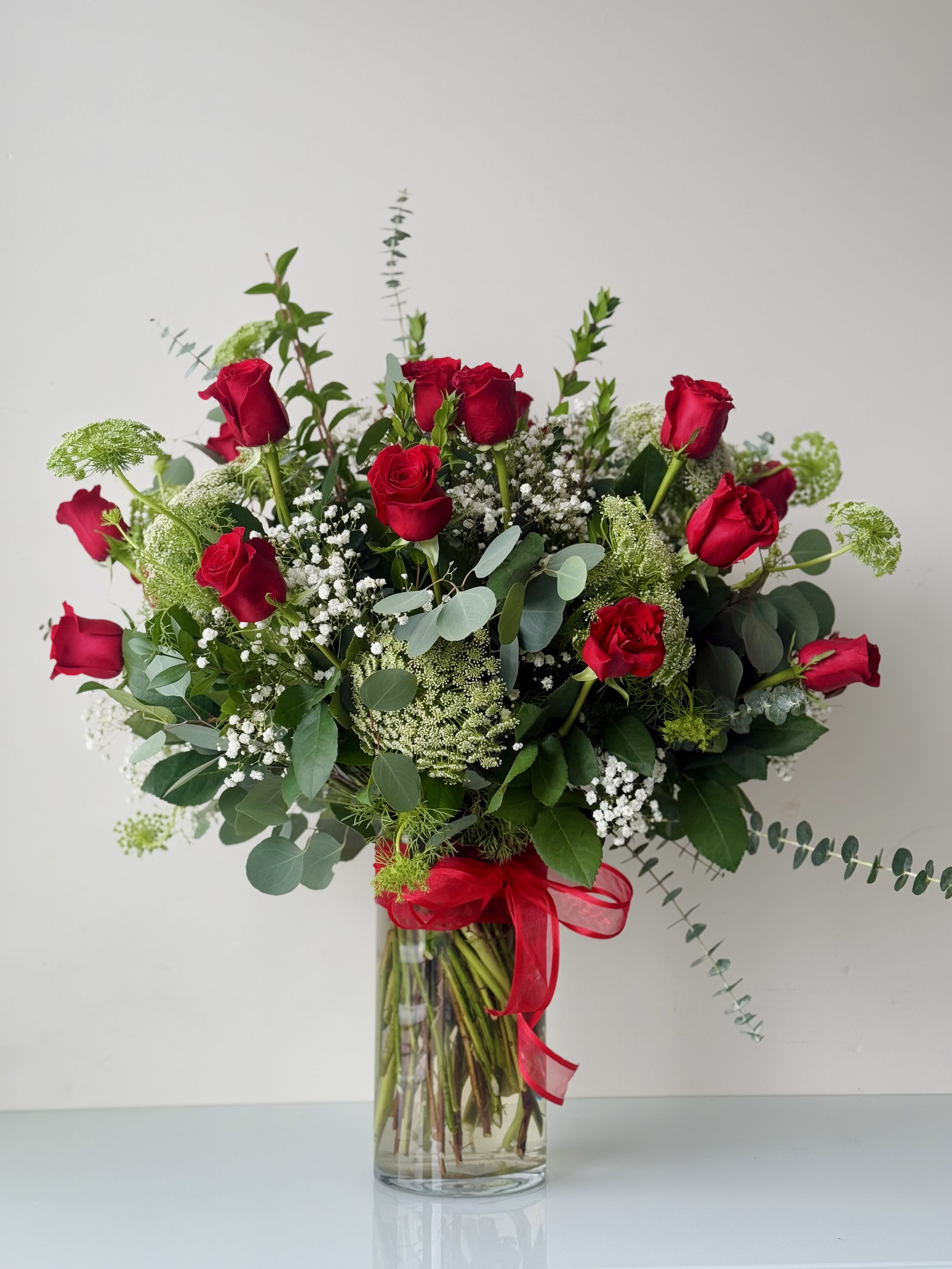  2 Dozen Roses Arrangement Standard - 24 Premium Freedom roses imported from Ecuador, with greens and fillers. Built in a 6”x12” glass vase.