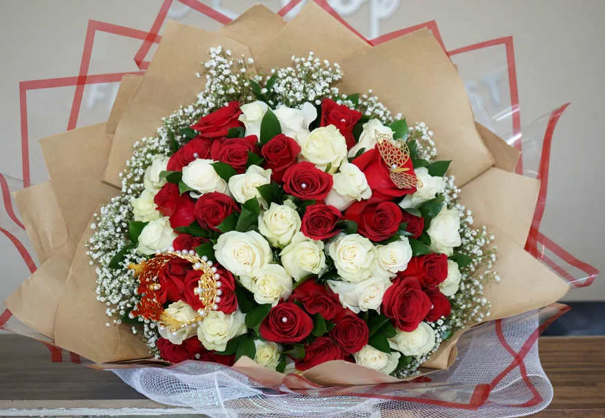 LIMITED SALE: The blushing romance bouquet - Surprise someone special with this timeless and elegant bouquet.  This vibrant arrangement features a beautiful mix of classic red roses and pure white roses, symbolizing love, passion, and innocence. Delicate baby’s breath is sprinkled throughout, adding a touch of sweetness and airiness. This bouquet is sure to bring a smile to anyone’s face.