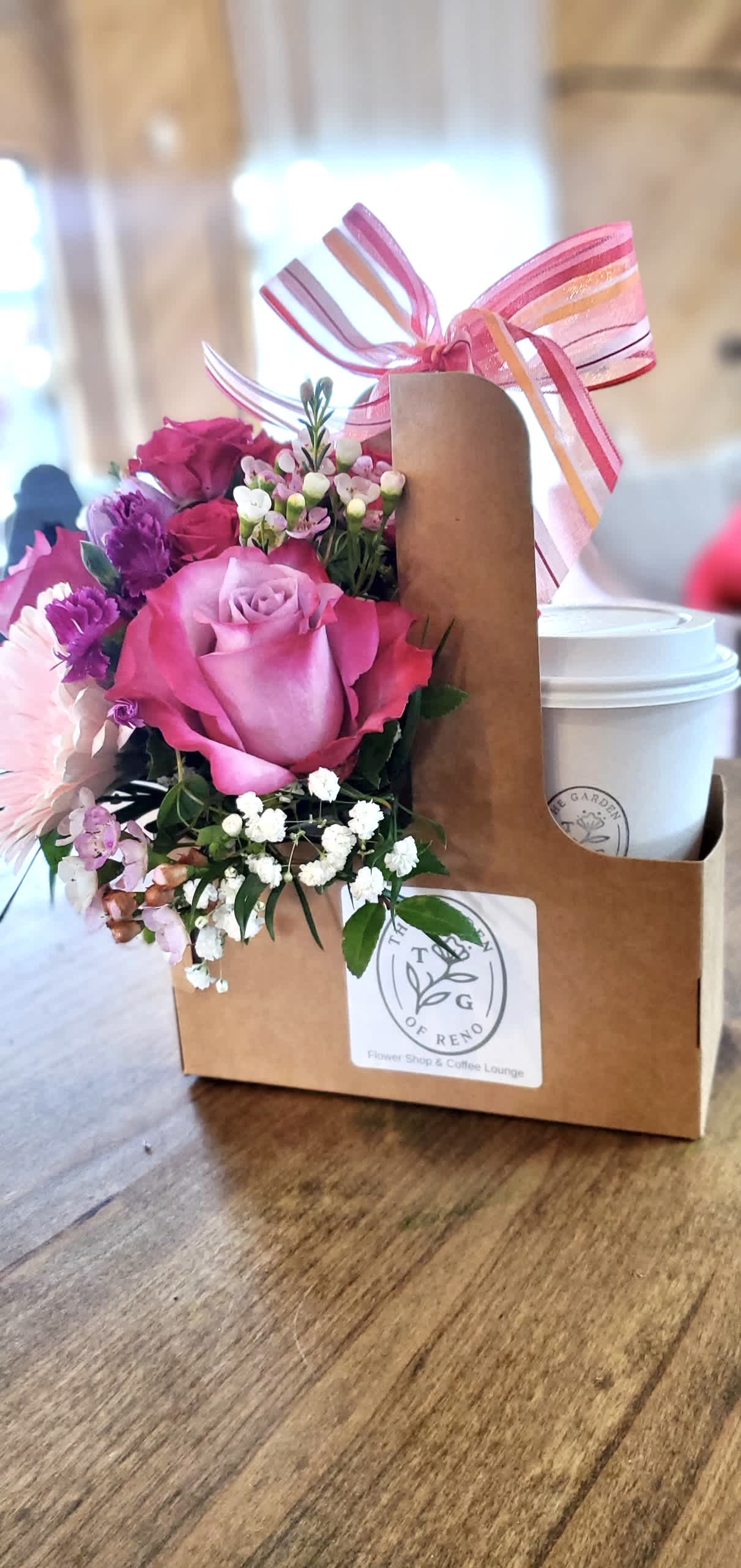 Love You A Latte - This is such a unique gift for all coffee and flower lovers!  Coming with a $20 gift card to The Garden of Reno.  A beautifully crafted sugar cookie.  All put together in an on the go carrier holding, petite seasonal Floral Mix  (will vary from the photo) .  -Ordering this online doesn't include a coffee, it includes the display cup holding the gift card and sugar cookie. In shop orders can only take away this product with a coffee added-