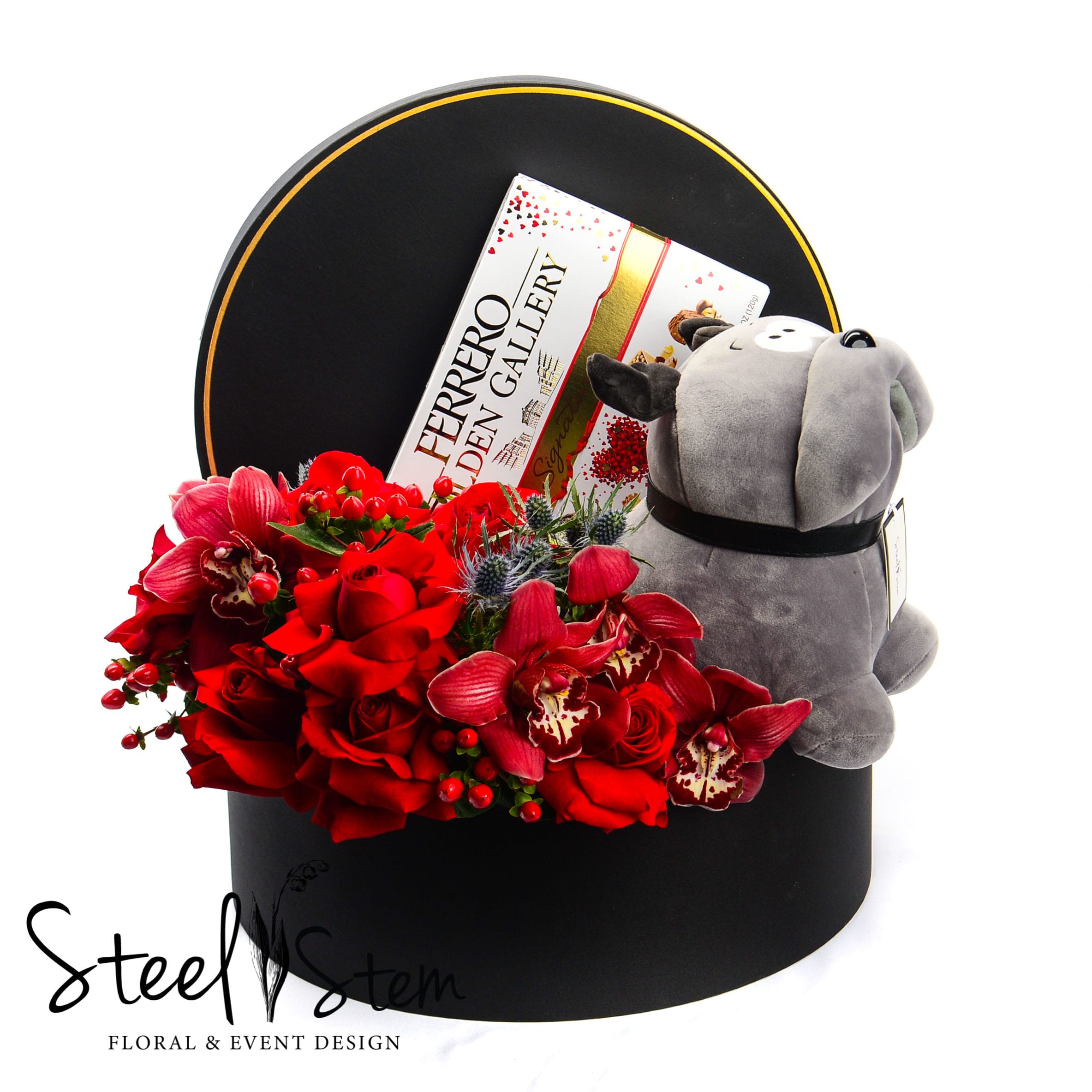 For Him - A black luxury gift box is combined with Ferrero Rocher Chocolates, classic red roses, beautiful cymbidium orchids, coffee beans, thistle flower.   Choose this gift to send your love one in the most romantic way possible and really treat that special someone to a luxury gift they'll never forget! This box is reusable and can be easily repurposed for home decor or to refill with more flowers!   Approximately 15" L x 12"D.