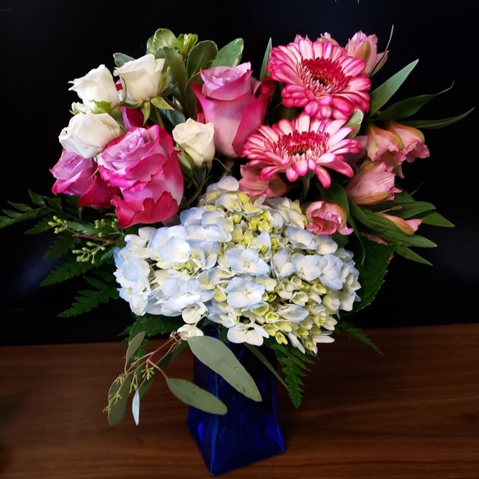 Cheyenne - Lavender Roses, Blue Hydrangeas, Gerber Daisies, Alstroemeria accented with seeded Euc…. A romantic combination of colors for date night or just a surprise reminder of the love you to share everyday.....