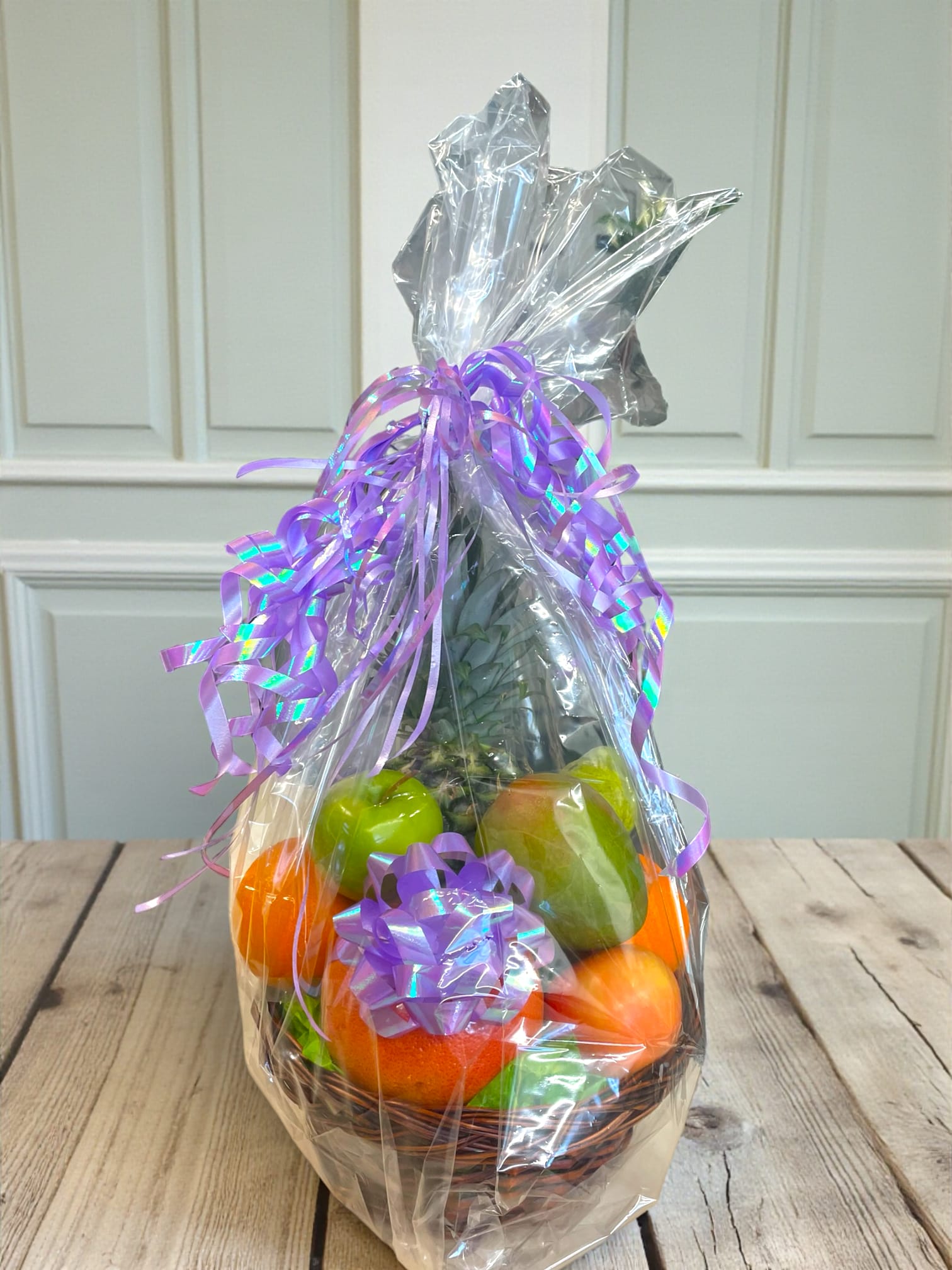 Orchard Delight Fruit Basket  - Starting at $79.99, The Orchard Delight Fruit Basket is a vibrant and inviting assortment of fresh, premium fruits beautifully arranged in an elegant basket. This delightful collection features a luscious pineapple, juicy mango, tangy grapefruit, sweet orange, crisp pear, and flavorful apples, creating a harmonious blend of colors and tastes. Each fruit is carefully selected for its quality and ripeness, ensuring a delicious and nourishing experience with every bite. The Orchard Delight Fruit Basket is perfect for gifting or sharing, offering a healthy and eye-catching centerpiece that brings a touch of orchard-fresh goodness to any occasion.  Basket made to value.