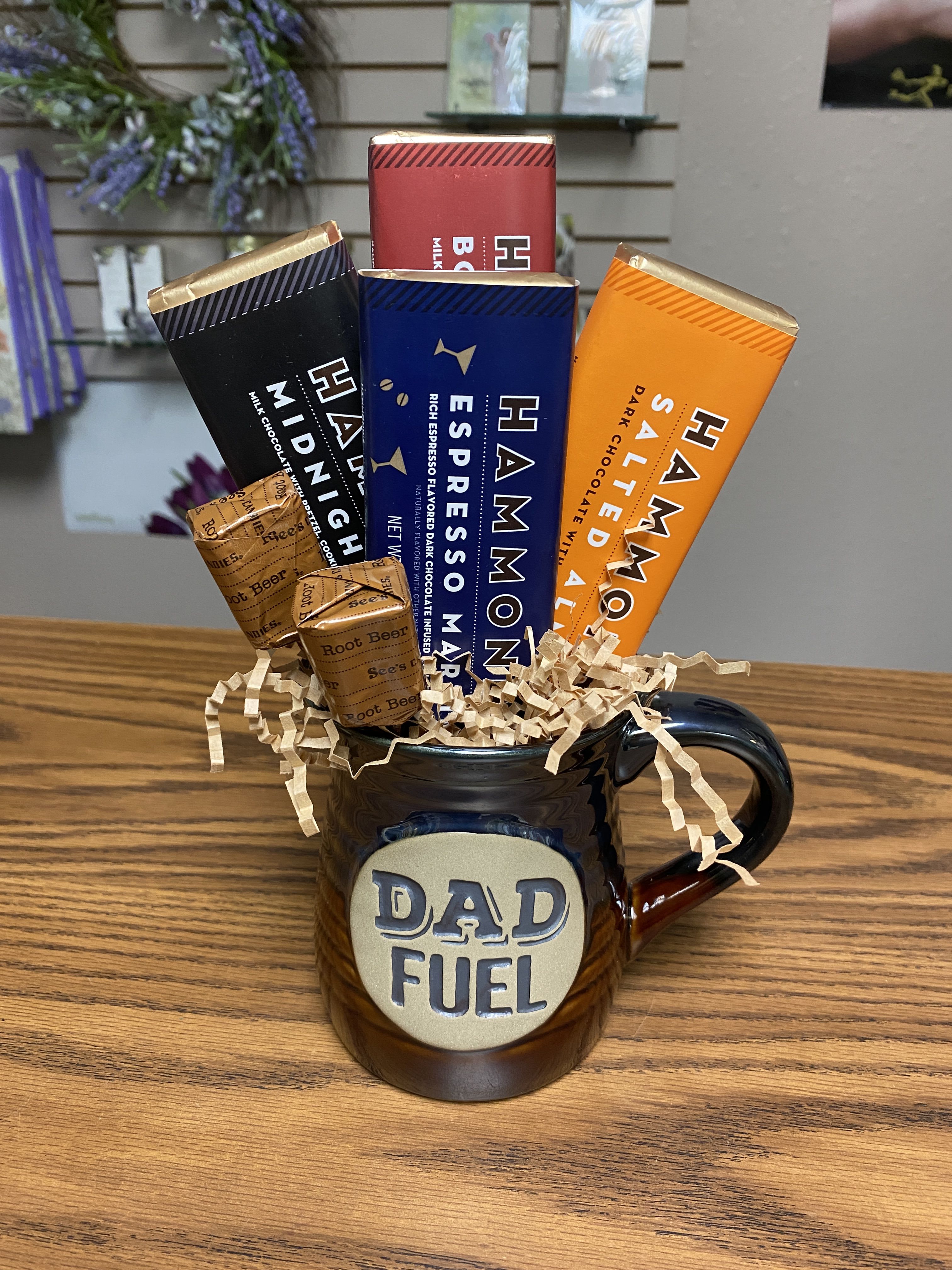 Dad Fuel Gift Set - The Dad Fuel Mug Set includes: 1 Dad Fuel Mug, 1 Hammond's Espresso Martini Chocolate Bar, 1 Hammond's Midnight Snack Chocolate Bar, 1 Hammond's Bourbon Pecan Pie Chocolate Bar, 1 Hammond's Salted Almond Chocolate Bar, and 2 Root Beer See's Suckers