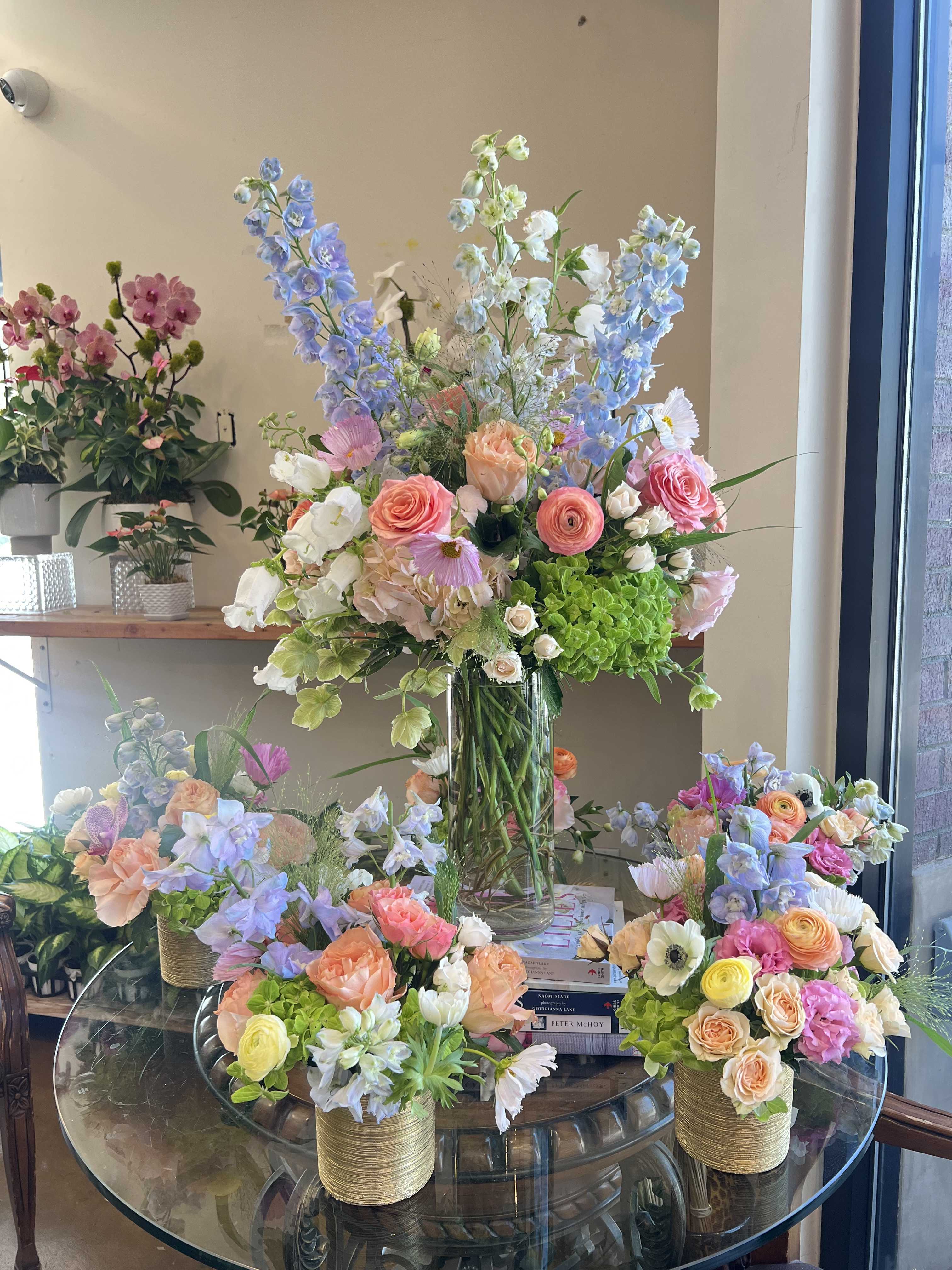 Summer Party Set - Bring effortless charm to your next gathering with our Summer Party Set. This curated package includes six small cheerful pastel arrangements &amp; one show-stopping large pastel centerpiece. Designed in soft, seasonal hues, these arrangements add the perfect pop of color and fresh elegance to any summer or spring celebration—whether it’s a garden brunch, bridal shower, or backyard soirée. Celebrate in style with blooms that capture the breezy beauty of the season!  1 tall arrangement: $175 5 small arrangements: $65 each 