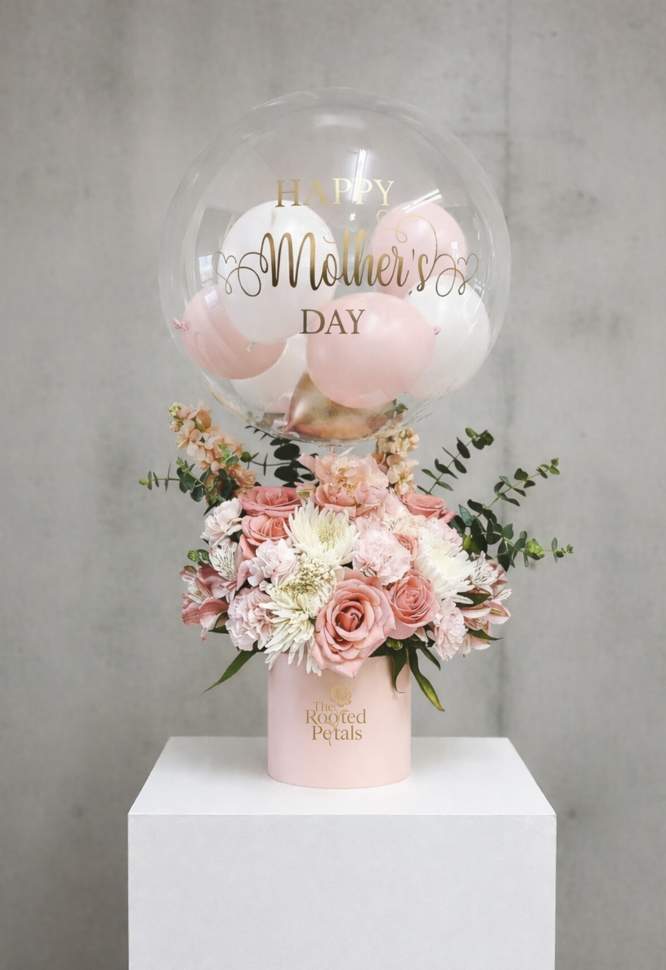 Mom’s Blossom Surprise - Celebrate the extraordinary woman in your life with our "Mom's Blossom Surprise." This enchanting arrangement features a vibrant bouquet of fresh, seasonal blossoms, hand-selected to evoke the warmth and love of motherhood. Delicate roses, cheerful daisies, and elegant tulips blend beautifully, creating a stunning visual display.  Accompanying the floral delights are playful, colorful balloons that add a touch of whimsy and joy to the occasion. Perfect for a heartfelt Mother’s Day gift, this arrangement is designed to bring smiles and create lasting memories. Surprise Mom with this delightful fusion of blooms and balloons, and show her just how much she means to you!  Customization Details: We offer customizable fonts to add a personal touch. Please note that a minimum of 3 days' notice is required prior to the delivery date to ensure your customized piece is perfect. Surprise Mom with this delightful fusion of blooms and balloons, and show her just how much she means to you!