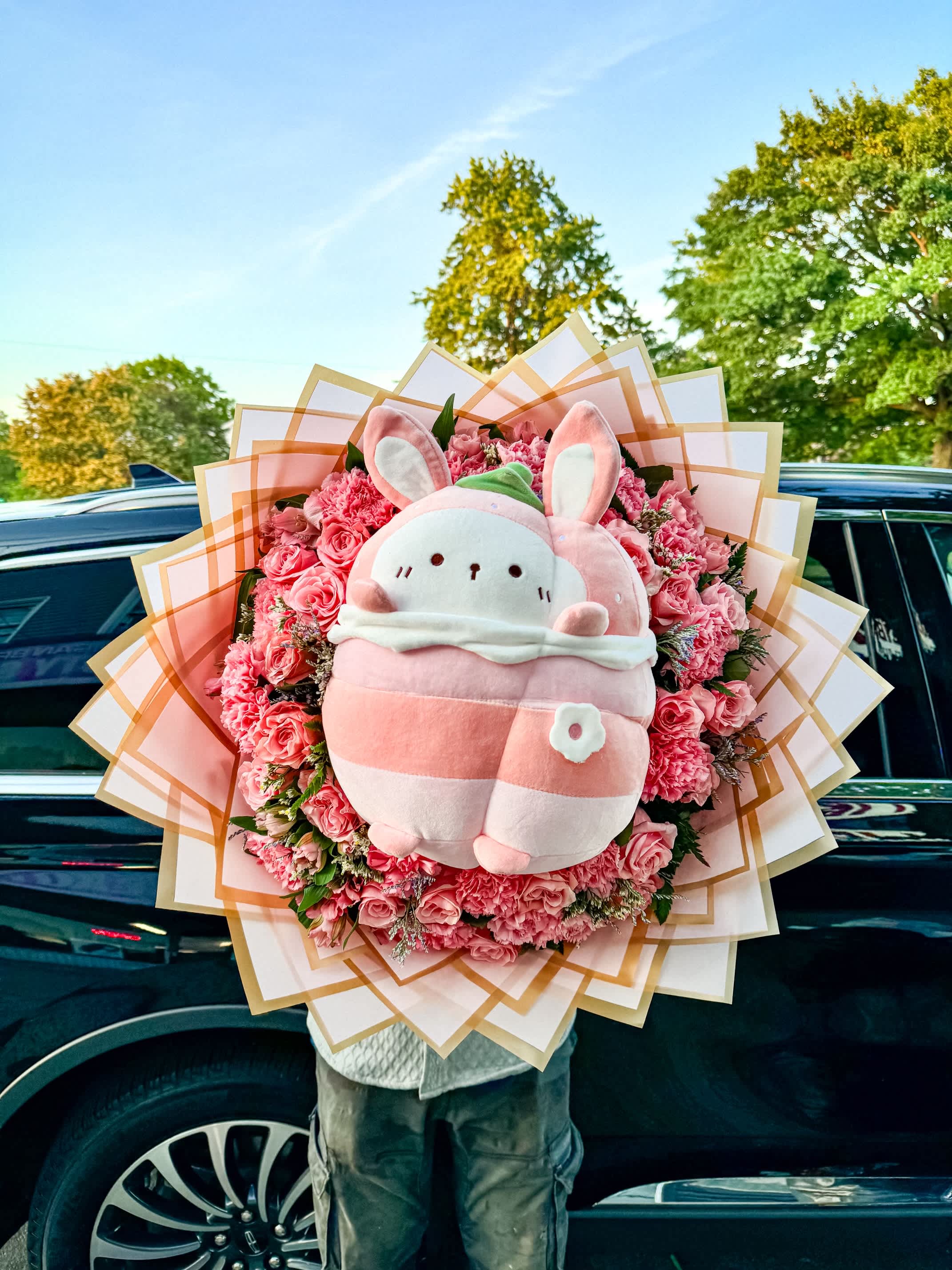 Roses and Teddy Serenade -  A charming bouquet of vibrant red roses delicately arranged, complemented by lush greenery that adds a touch of freshness. Nestled among them is a cuddly teddy bear, its soft fur contrasting beautifully with the richness of the roses. Together, they create a perfect gift, blending the elegance of flowers with the warmth of a cherished teddy bear.