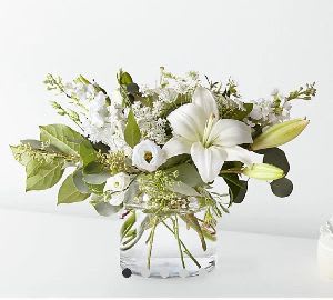 Pure  Centerpiece - An elegant all-white design that brings a sense of serenity and timeless sophistication.  Each piece is Designer’s Choice, created with fresh seasonal blooms. Flowers and colors may vary based on availability while maintaining the overall style and quality.  Best for: elevating weddings, enhancing formal dinners, or adding refinement to meaningful gatherings. 
