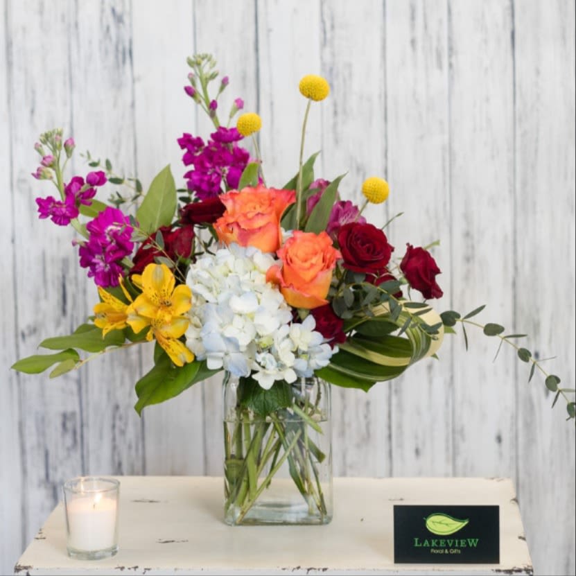 Lively - Sure to cause a stir, this modern arrangement of bright blooms includes hydrangea, craspedia, stock and roses.  Approximate Dimension: 16" W x 13" H