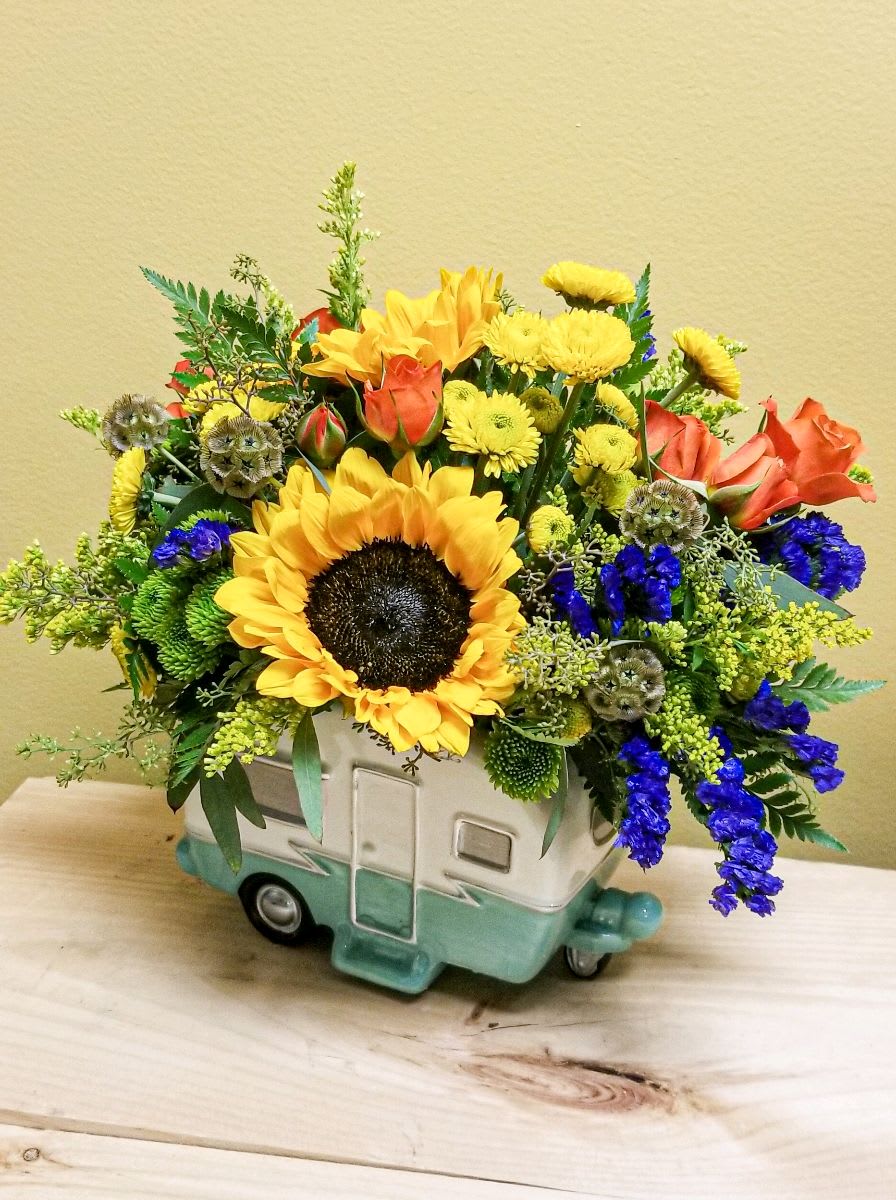  Retro Road Tripper Bouquet - This retro-fabulous gift features yellow sunflowers, yellow button spray chrysanthemums, green cushion spray chrysanthemums, blue eryngium, blue sinuata statice, parvifolia eucalyptus, solidago, and leatherleaf fern. Delivered in a Retro Road Tripper Camper. Approximately 13" W x 11 1/2" H