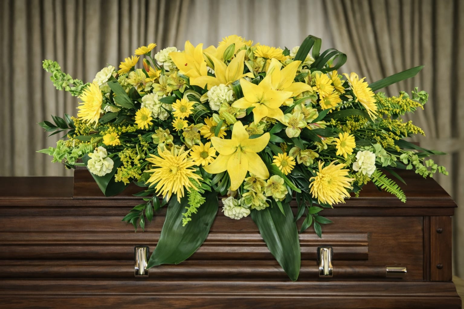 Sunshine Casket Spray  - Vibrant yellow and white flowers are beautifully arranged in a floral casket spray.   A unique arrangement hand-created by our experienced designers. Please note that every design is custom-made and substitutions to the container and flower types may happen from time to time. Design aspects will always stay the same, but if needed, we will substitute with flowers of equal or greater value to offer you a great floral shopping experience! Our flowers are 100% guaranteed. Please call us with any questions or concerns.