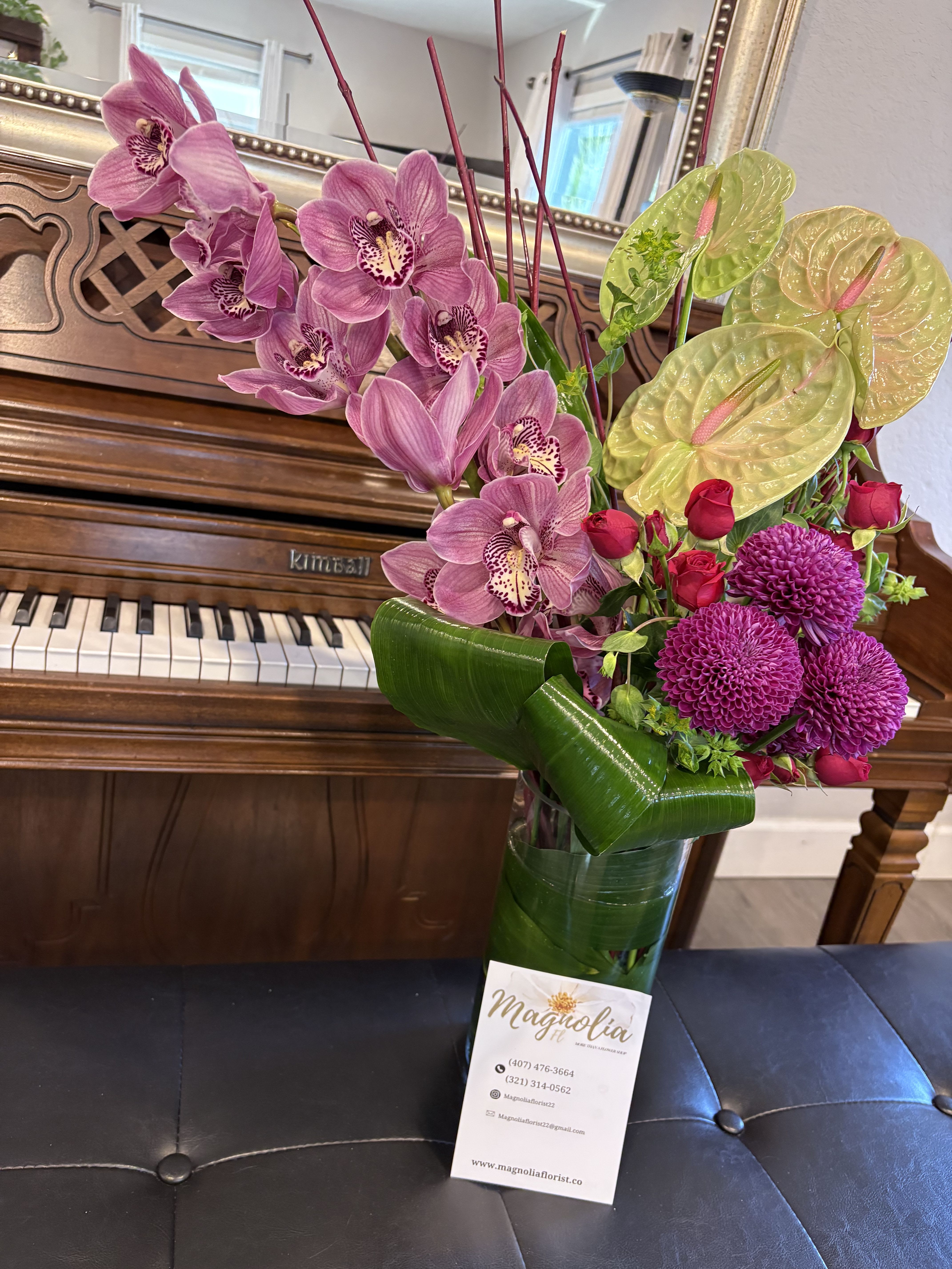 Radiant Bloom Symphony - A striking assembly of vibrant petals and lush greenery, this floral arrangement exudes energy and vitality. Each flower interplays with its neighbors, creating a dynamic visual and olfactory experience that captivates and inspires. Perfect for elevating spaces and brightening any occasion