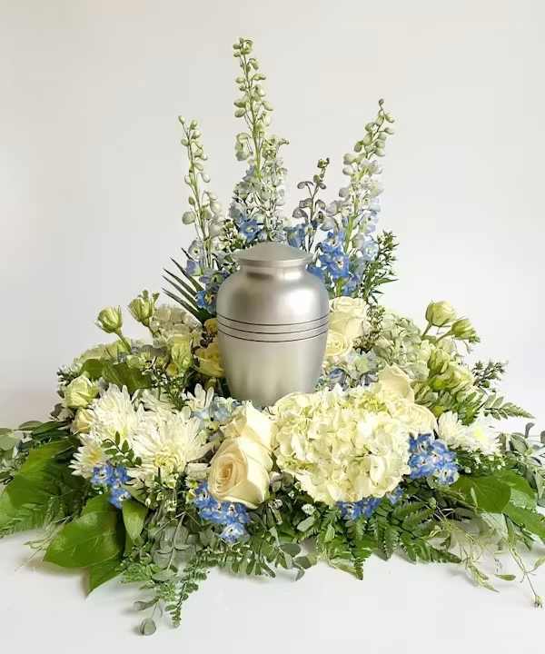 Blue Skies Above Us - Blue and white wreath for cremation urn. Beautifully arranged to surround sympathy urn with love.  Some flowers may vary based on season availability. *Urn not included.