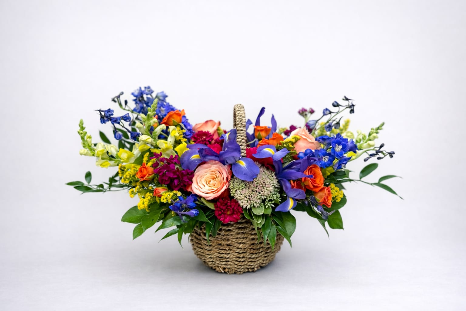 Mondrian Basket - Classic garden basket with a primary color palate including kahala roses, snap dragons, orange spray roses, iris and delphinium.  