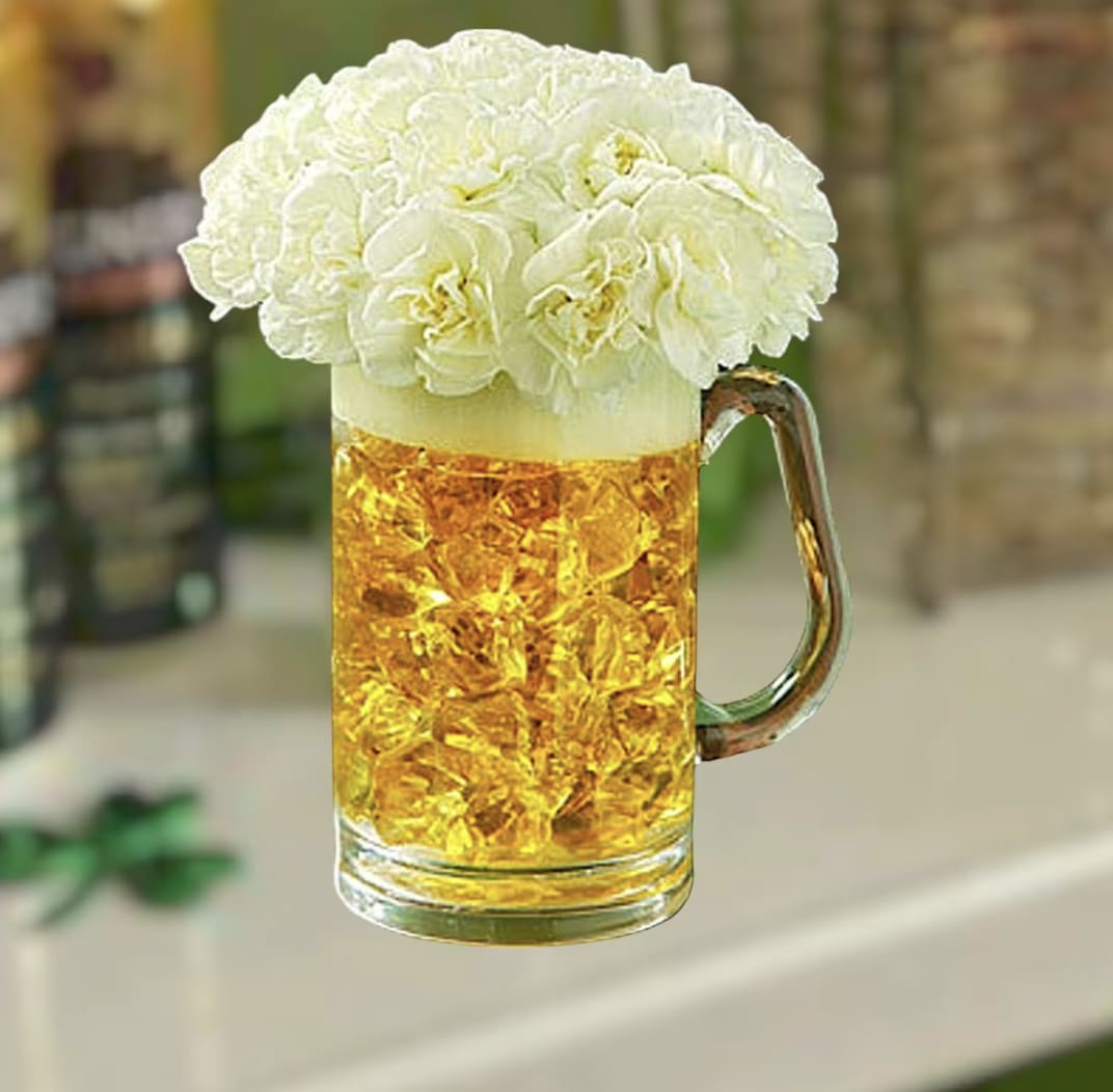 BEER - FOR that special someone who enjoys a pint now and again.  White carnations , yellow stone in a reusable beer mug.