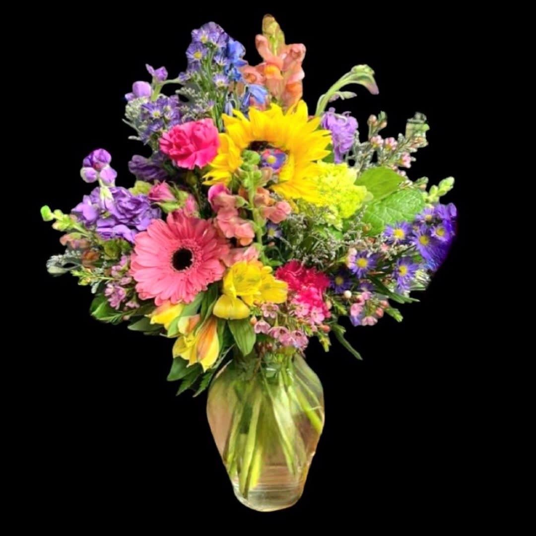 Bold Wishes - This arrangement is a mix of flowers and bold colors. It will brighten any room and it's guaranteed to bring a smile. 