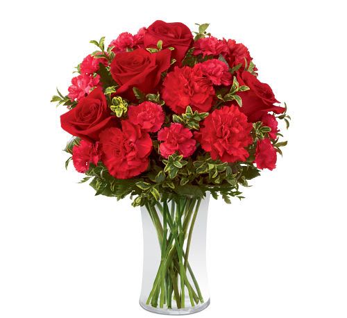 Always True Bouquet - Blossoms with love's tender message. Rich red roses and carnations are accented with fuchsia mini carnations and lush greens arranged to perfection in a classic clear glass vase to create an exceptional way to convey your heart's most intimate wishes.