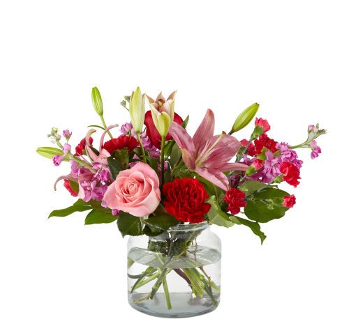 Date Night In Bouquet - Cozy up with the one who matters most with the Date Night In Bouquet. This delicate display of red carnations, light pink stock, pink lilies, and roses designed in a clear cinched vase will bring romance to your sweetheart and your space.