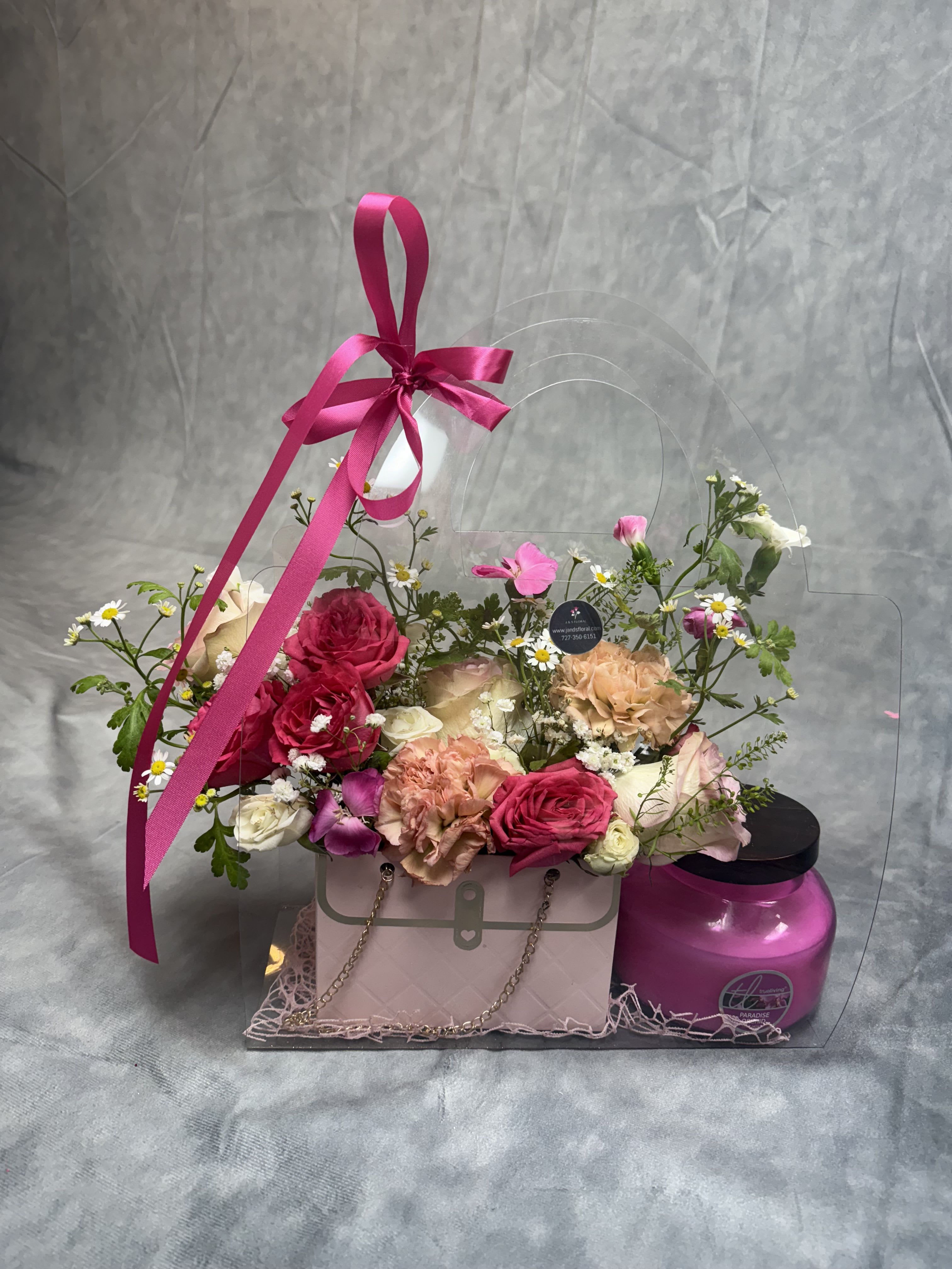 Joyful Sweet Flames Bag - Introducing our Joyful Sweet Flames Bag  a heartwarming trio featuring a charming floral purse arrangement, decadent chocolates, and a soothing scented candle. The perfect gift to spark joy and sweeten someone’s day! The candle scent may be changed depending on the availability. 