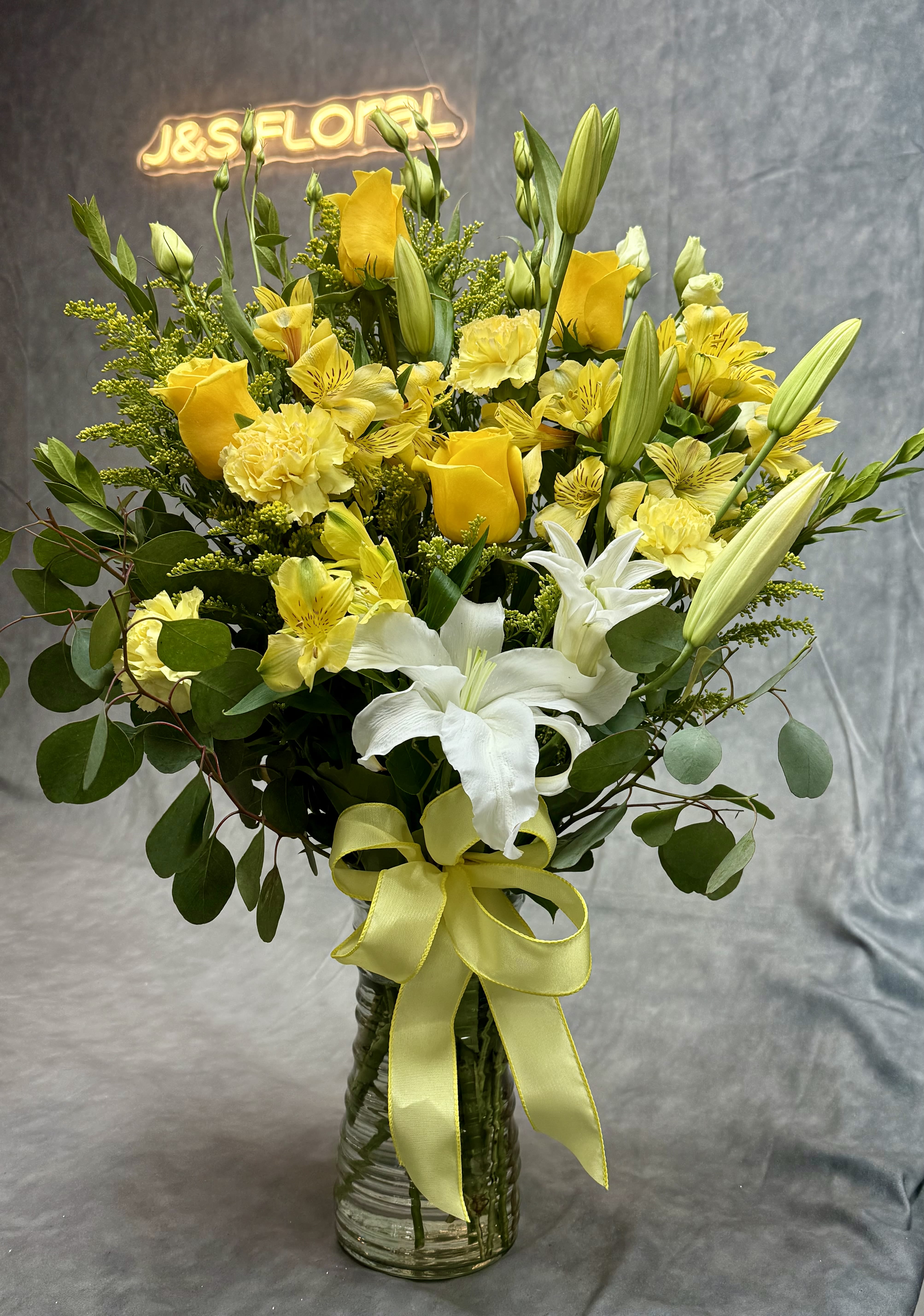 Yellow breeze - A refreshing blend of vibrant yellow roses and spray roses , yellow alstroemeria and elegant white lilies , capturing the essence of gentle breeze . Perfect for spreading warmth , joy and positivity in any space.
