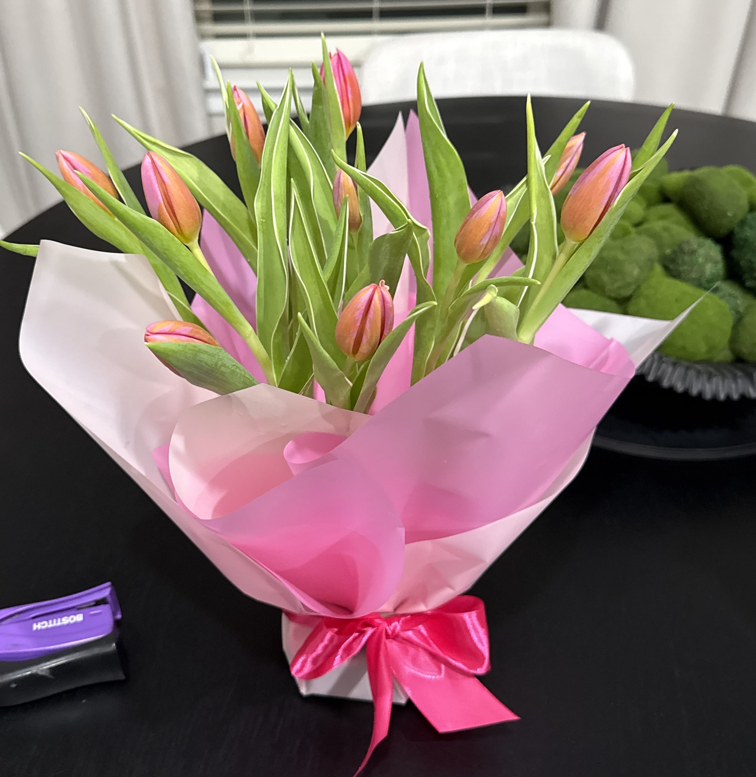 Pink Tulip Bouquet – Fresh Tulips Wrapped in Signature Style - Soft, romantic, and effortlessly elegant — our Pink Tulip Bouquet is designed to make hearts bloom.  Each bouquet features fresh tulips beautifully wrapped in our signature Lone Star Gifts presentation with premium wrapping and a satin ribbon finish. Perfect for birthdays, anniversaries, spring celebrations, or a sweet romantic surprise.   Important: Tulip colors may vary depending on seasonal availability and current in-stock selection. The photo shown is for design reference only. Your bouquet will be created using the freshest tulips available at the time of purchase while maintaining the same elegant style, shape, and fullness.