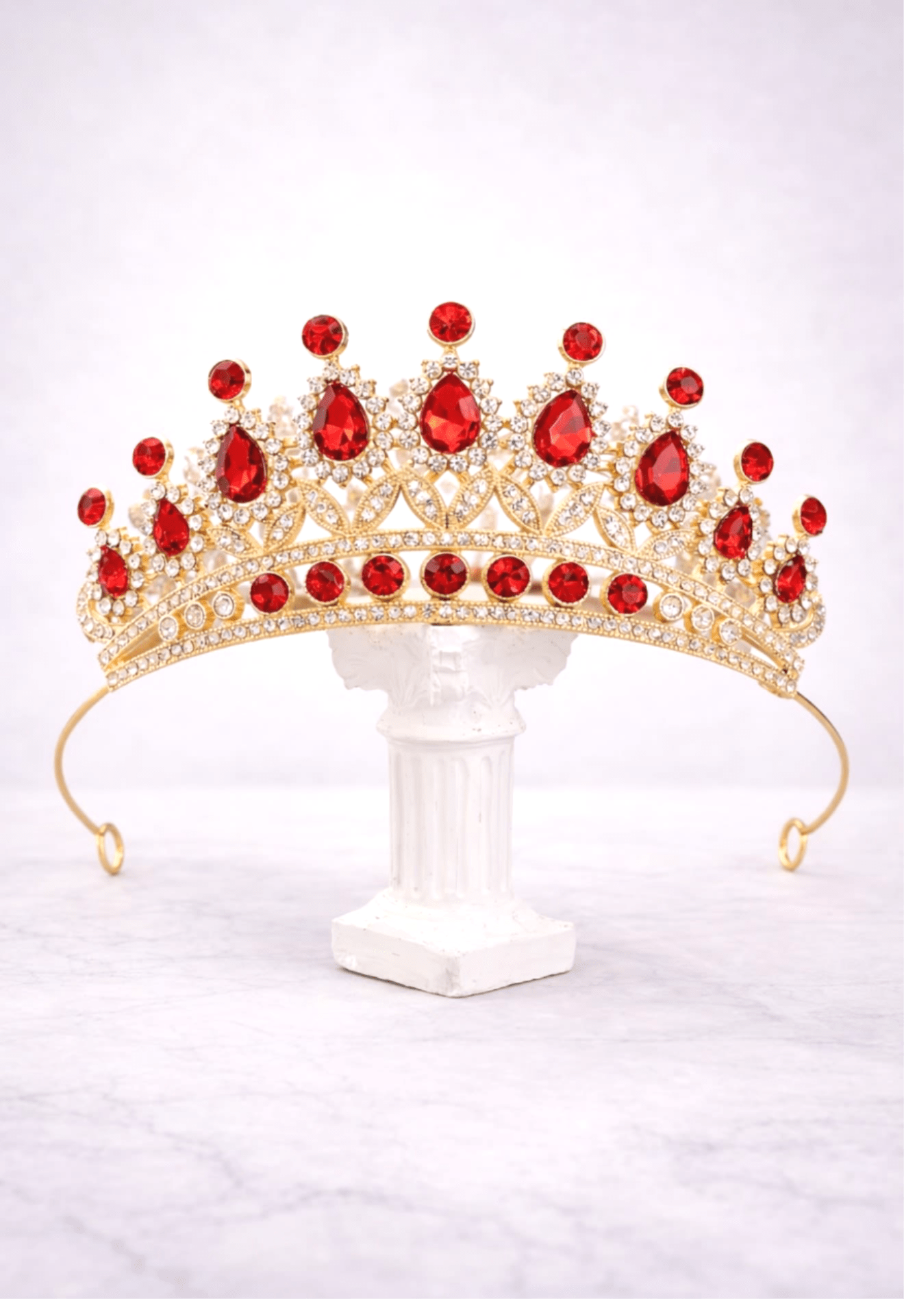 Ruby Royal Elegance Tiara - A regal gold-tone tiara featuring vibrant ruby-red stones and sparkling crystal accents. Bold, elegant, and perfect for any special celebration.