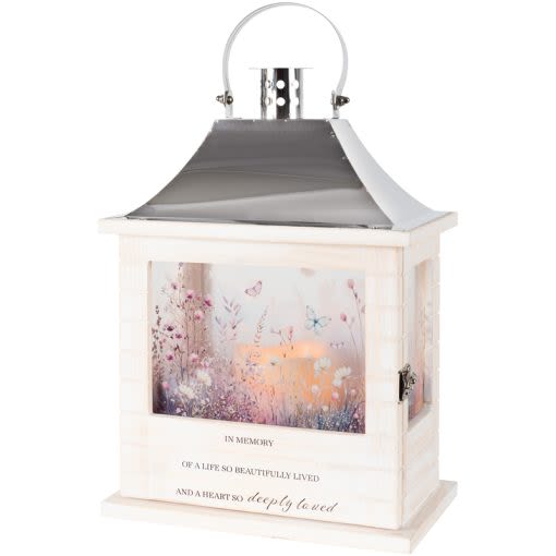 "In Memory" Wooden Slat Lantern - Our Wooden Slat lanterns are made with quality wood with a stainless steel finish top. They come inscribed with sentimental quotes amid beautiful artwork on all four sides and a charming flameless LED candle. Suitable for hanging or use as a freestanding item. Recommended as an accent in floral arrangements for many occasions. They are weather friendly! 3 AAA batteries are included.  Lantern Reads: "In memory of a life so beautifully lived and a heart so deeply loved"  W: 8.75" H: 12.5" D: 5.25"