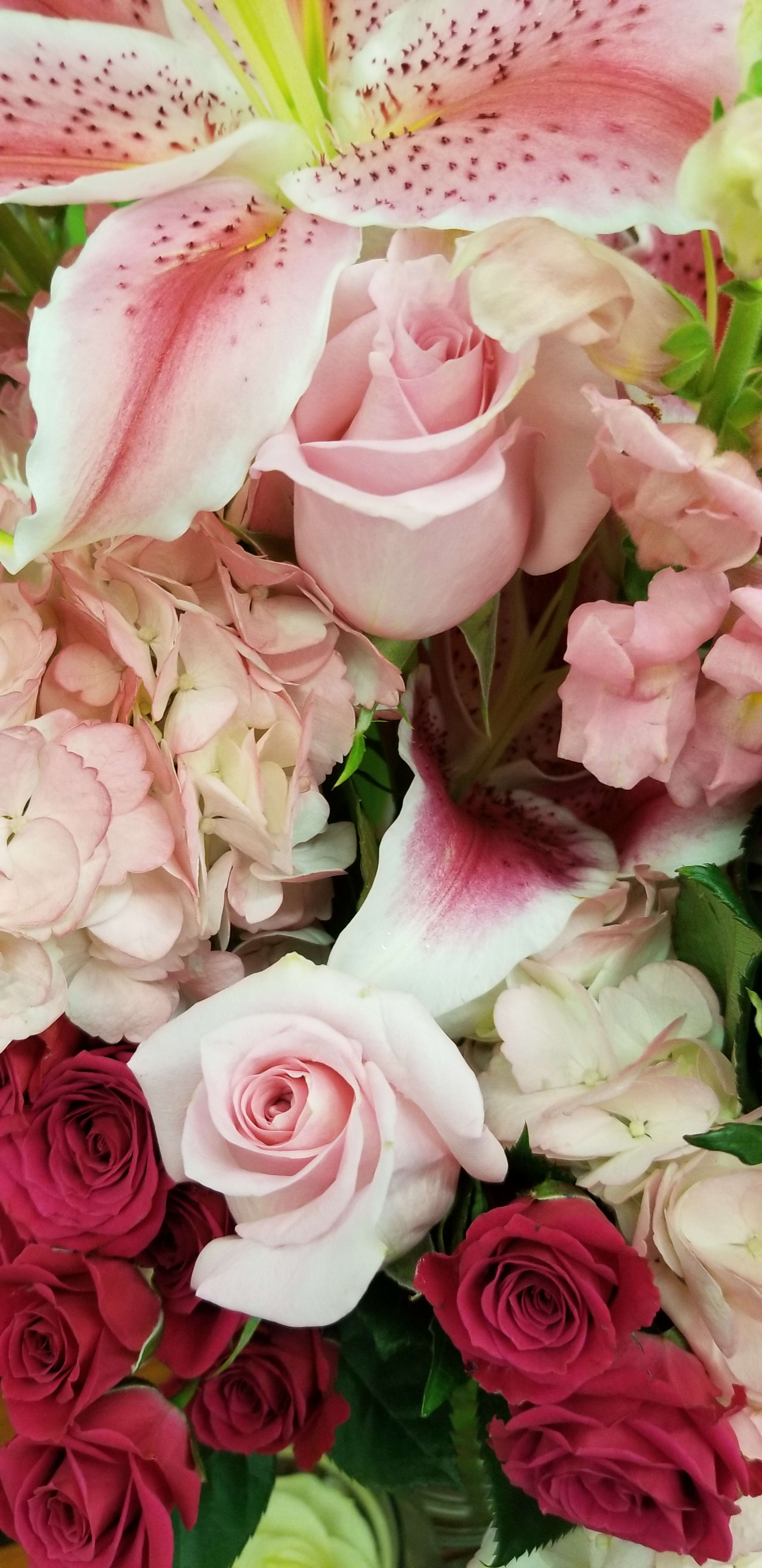 Designer's Choice shades of pink and white. - Our talented designers will create a bouquet in a vase from our fresh selection of flowers.  It will include different shades of pink.  The flowers pictured are just an example of what the designer may choose to use depending on your price point.