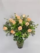Dozen Premium Peach Roses - A Dozen peach "Versilia" roses designed in a glass vase with greenery and filler by our floral team. Peach symbolized sincerity, appreciation, and gentle romance.  These premium, long-stemmed roses are timeless.