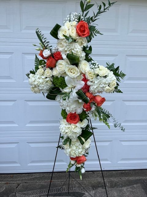 Irish Farewell - 30" L Sympathy Cross filled with beautiful white and orange roses, white lilies, white hydrangeas and mixed greens displayed on a stand.