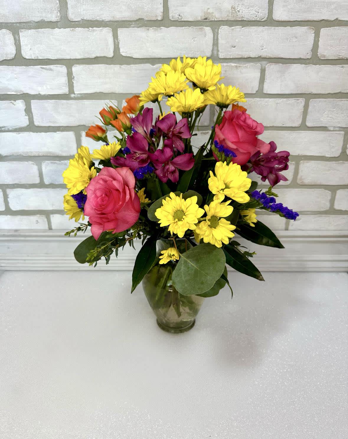 Beautifully Bright - Happiness in a vase! A cheerful bouquet of assorted blooms arranged in a glass vase. The perfect pick-me-up. 