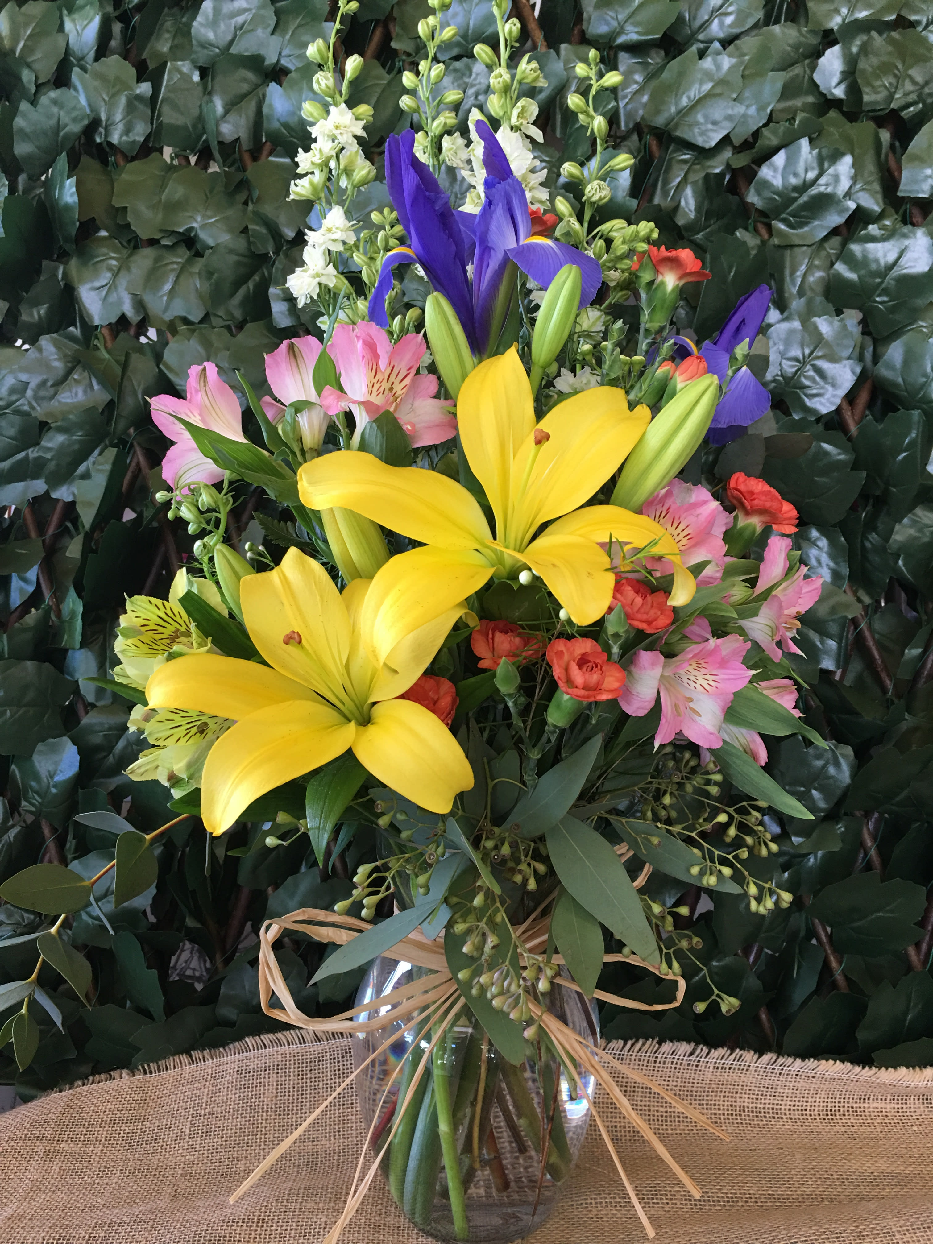 Cheer You - Seasonal bright flowers such as tiger-lilies, alstroemerias, mini carnation, iris and foliage arranged in a vase (one-sided)  NOT CAT-FRIENDLY FLOWERS  