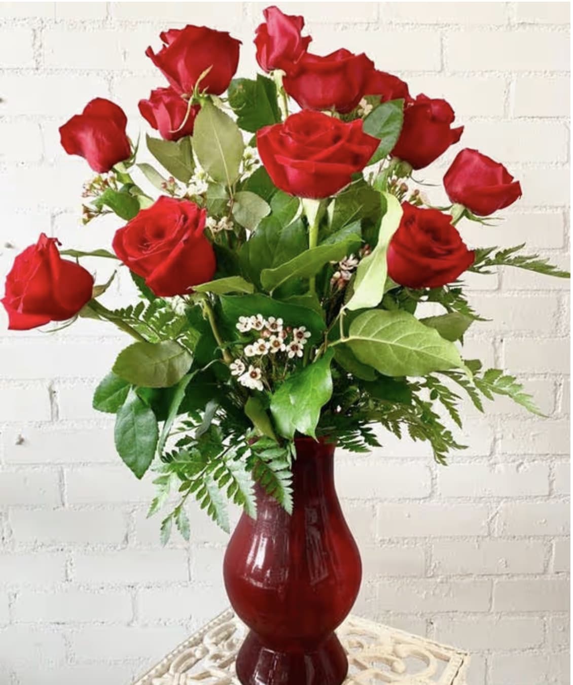 Dozen Long Stem Red Roses - Dozen Long Stem Red Roses with greenery, and a red vase