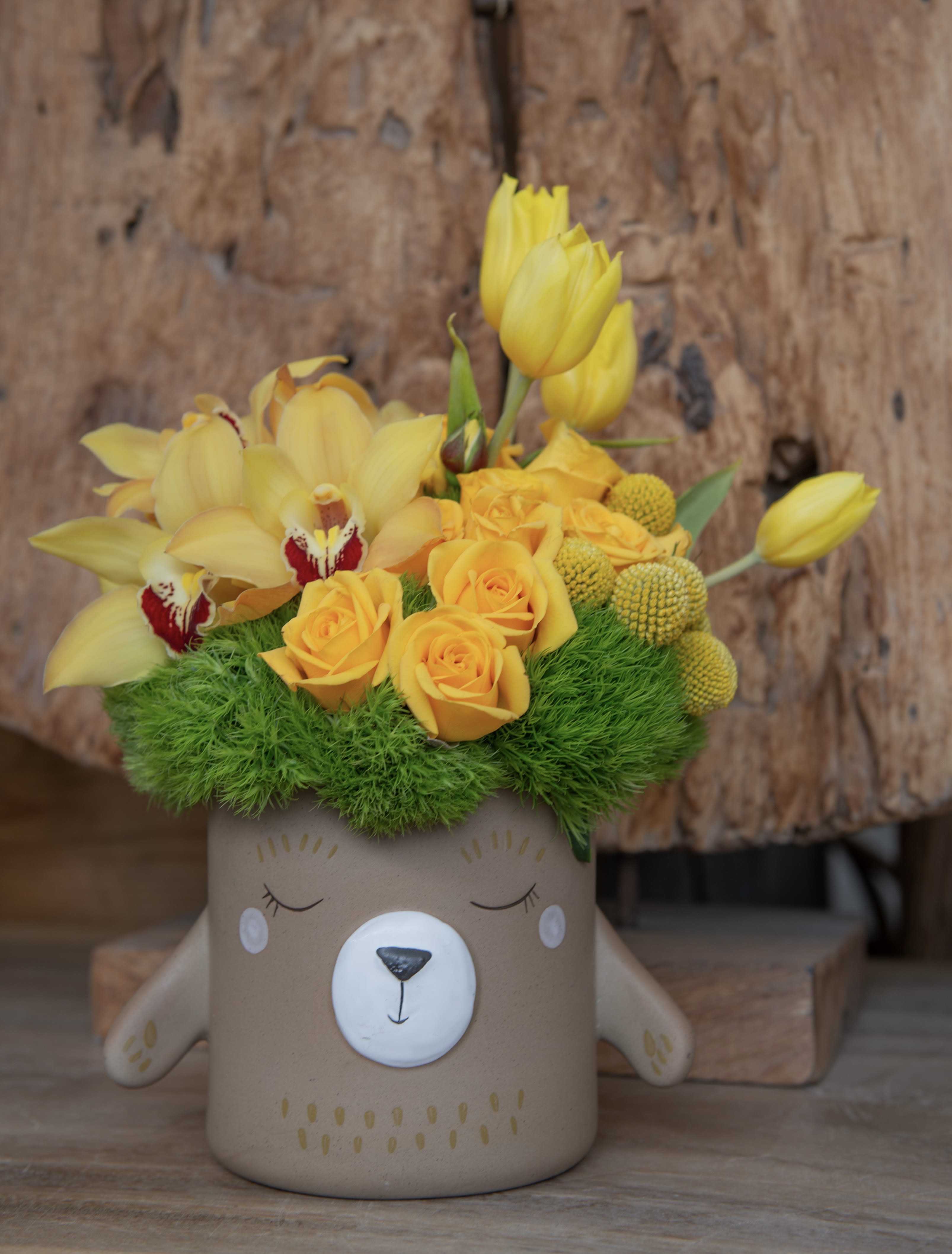 Miel - Our delicate ceramic hunny bear vase filled with the seasons yellow blooms.