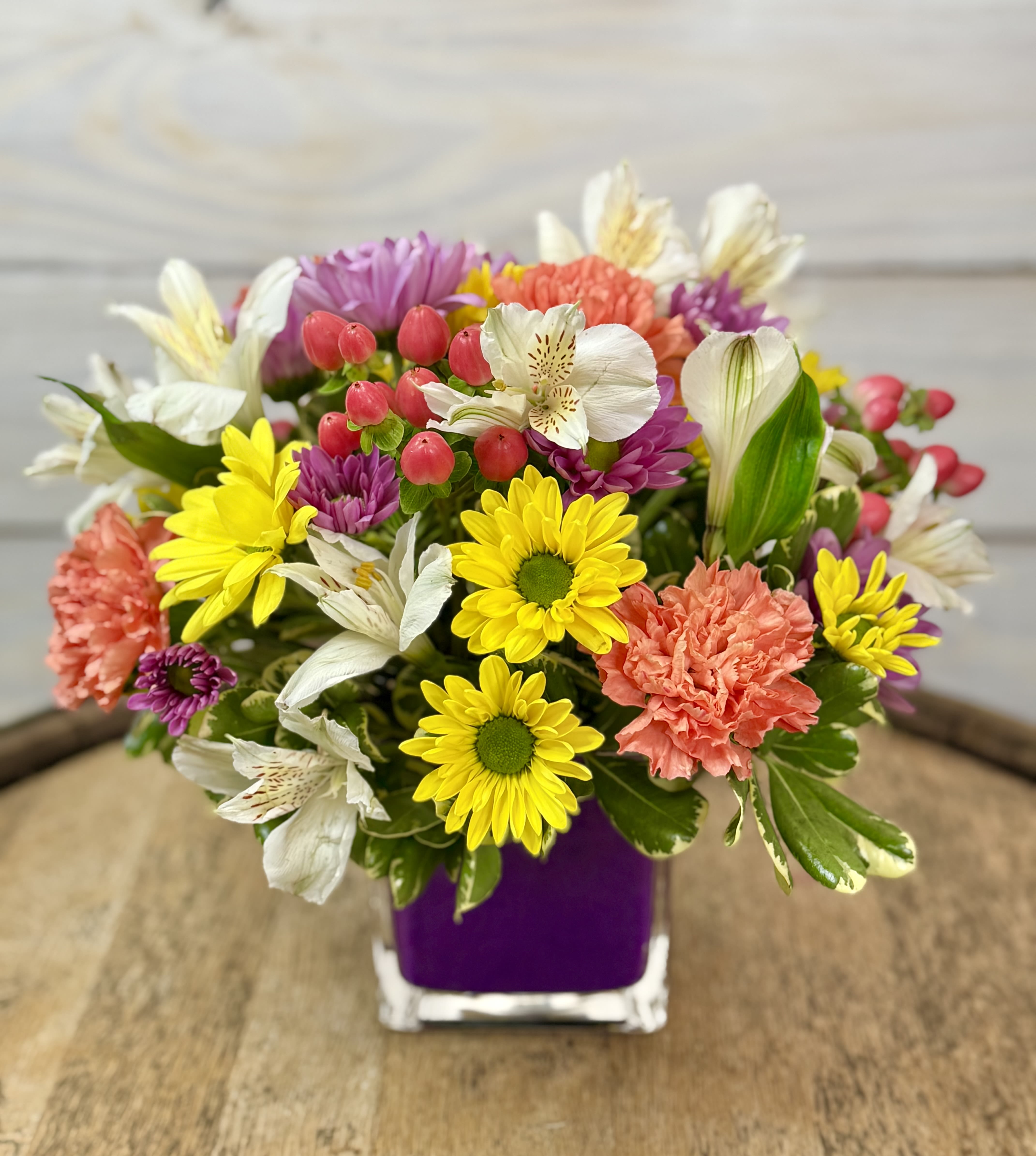 Blossom Breeze - A cute and colorful arrangement of spring flowers. Perfect for a desktop or your kitchen counter.  ****We will try our best to match the flowers in the picture, but there may be times when we substitute flowers. We will always try to make it have the same look and feel as the original.****